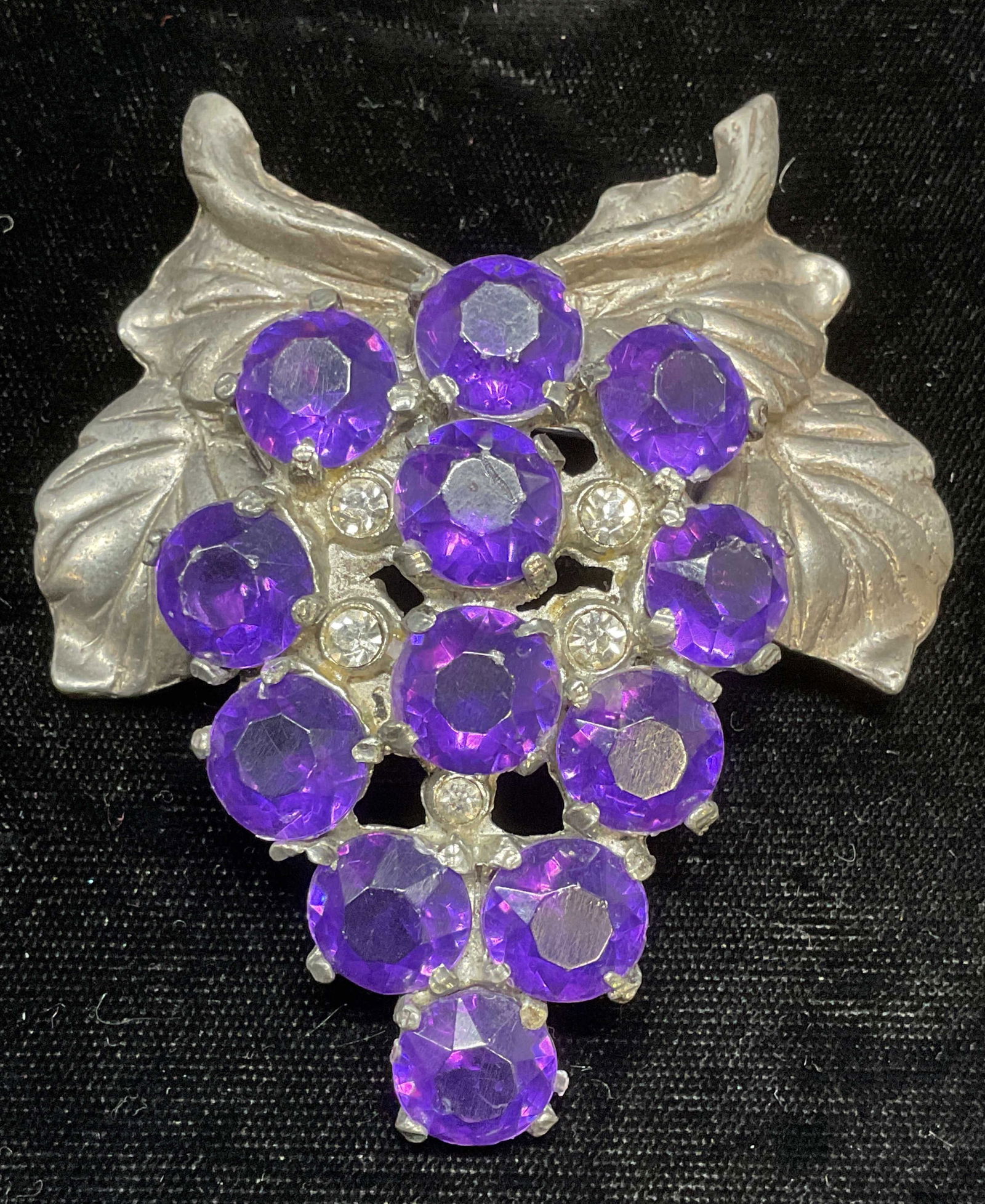 Roth Pewter Purple Crystal Grape Brooch, 3 In: Roth pewter grape motif brooch. Purple and colorless crystal. Measures approx 3 x 2.75 inches. Some wear including scratching observed. Jewelry, estate jewelry, costume jewelry, cocktail jewelry, fash
