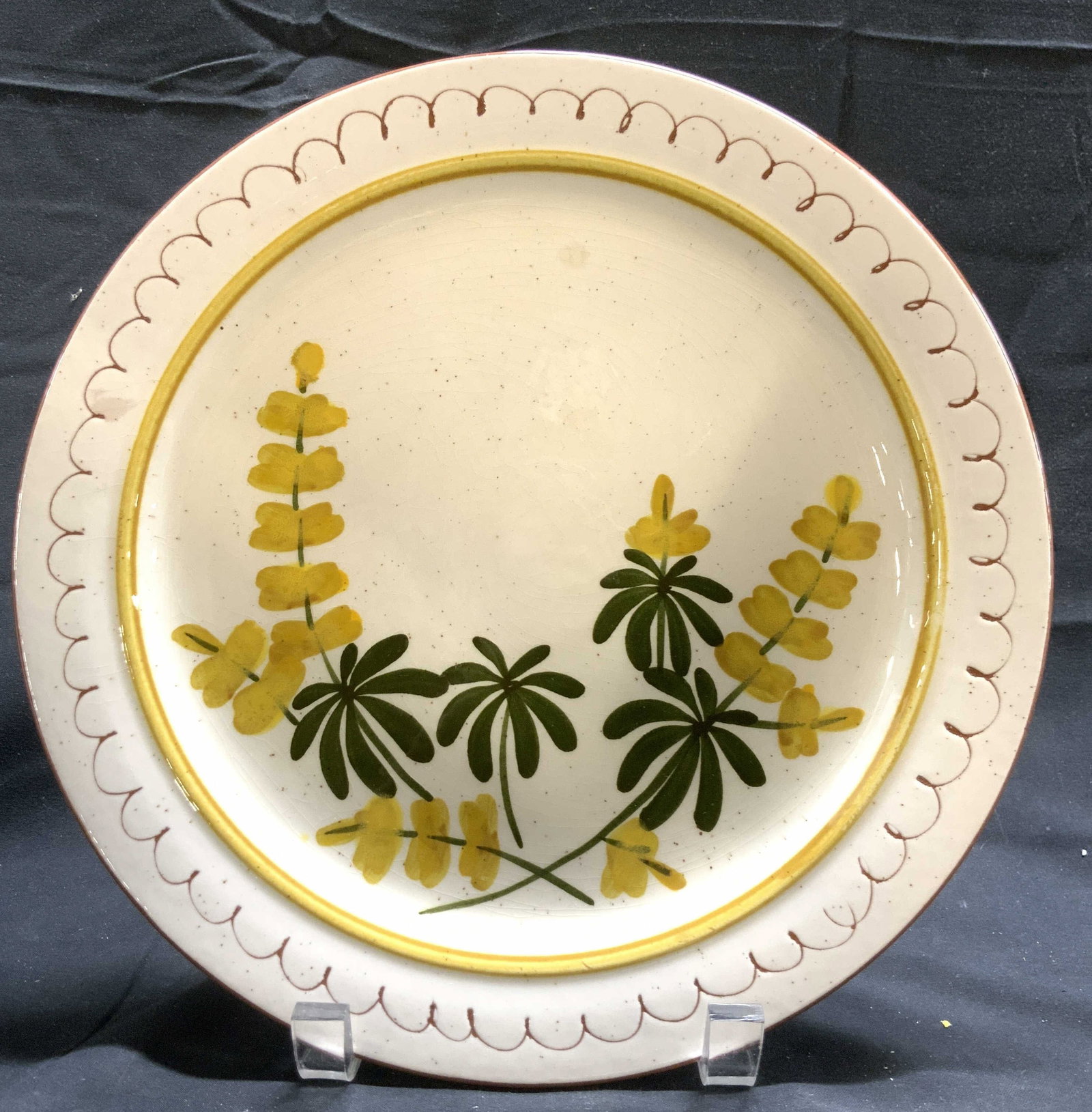 STANGL Hand Painted Ceramic Floral Detailed Plate: Underside is marked STANGL HAND PAINTED. Plate is ceramic. Piece has multi toned floral and leaf detail. Underside is terra cotta toned. Piece has squiggle curl detail around edges. Plate measures app