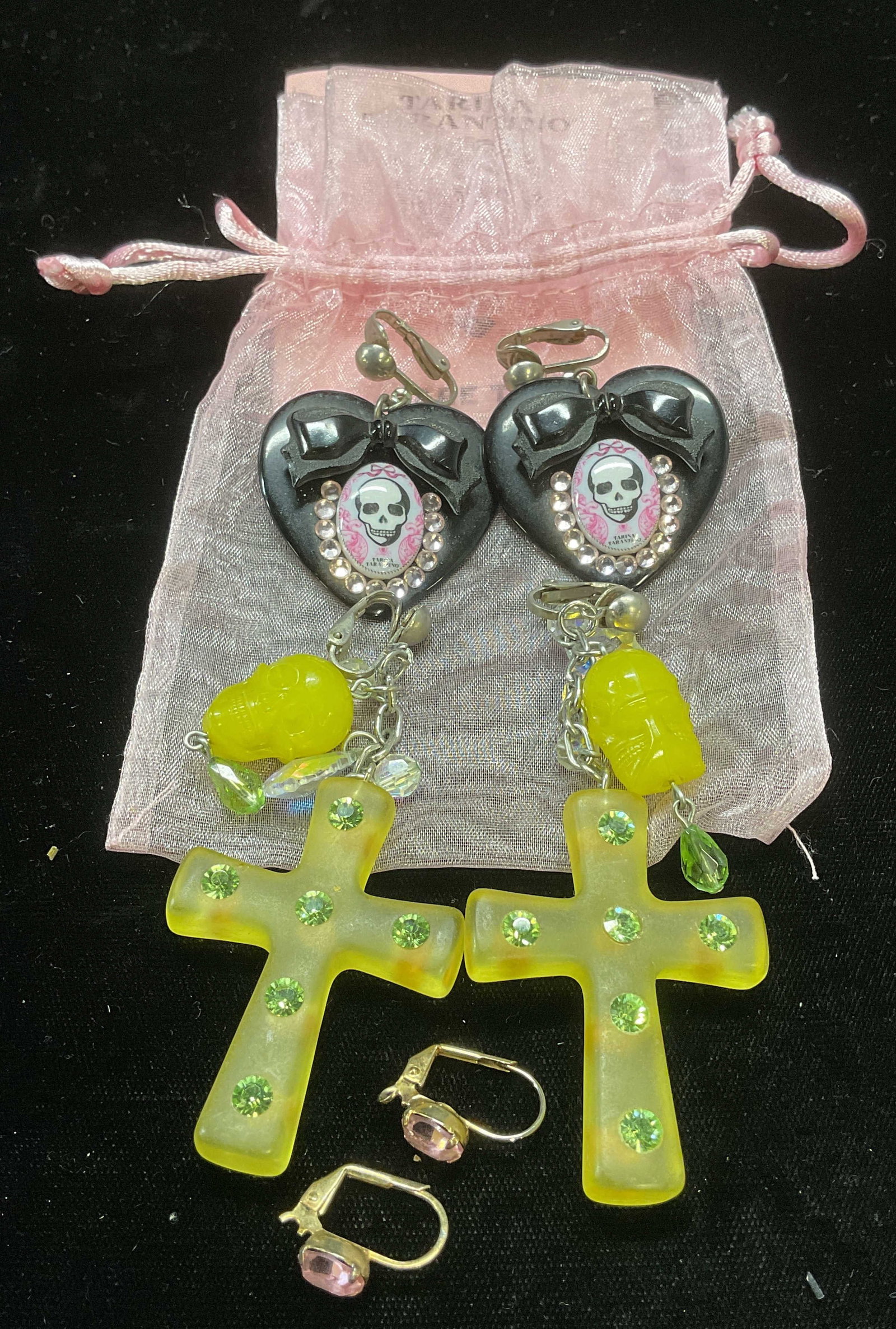 Lot 3 Tarina Tarantino Pendant & Crystal Earrings: Lot of 3 pairs of Tarina Tarantino earrings. Black heart and skull pendant earrings, green skull and cross pendant earrings, and gold tone pink crystal earrings. Swarovski crystal accents. Largest app