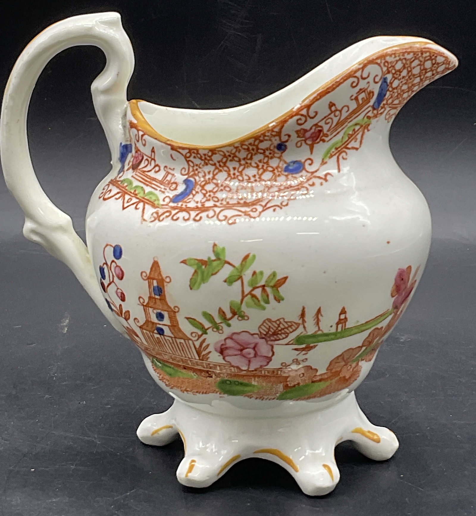 Vintage Hand Painted Chinoiserie Porcelain Creamer: Vintage Hand Painted Chinoiserie Porcelain Creamer / Pitcher / Pourer. Hand painted details to the piece. Scene features a pagoda, florals, foliage, and geometric designs. Footed. Measures approx. 5H 