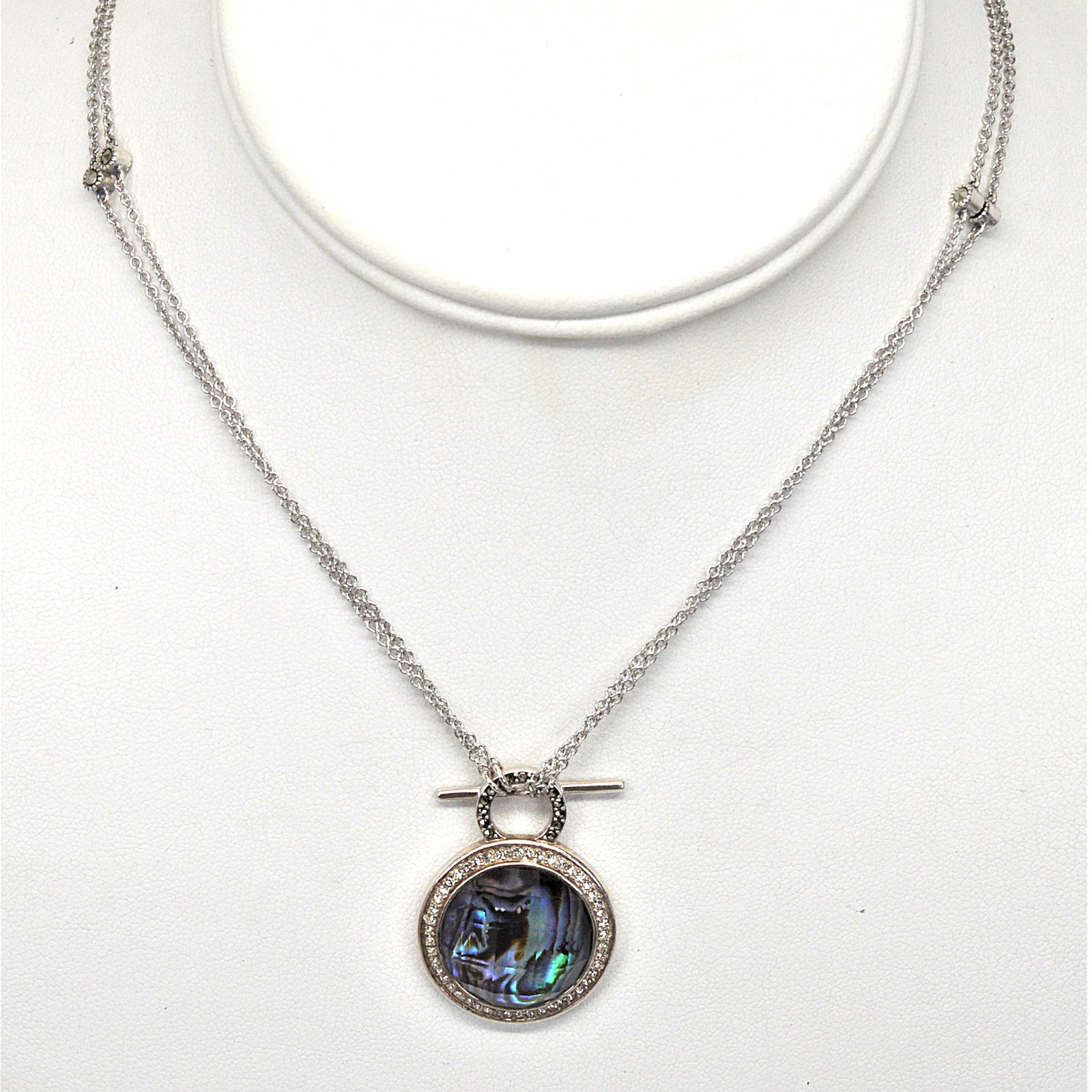 Sterling Silver & Mystic Quartz Necklace: Convertible sterling silver necklace can be worn at 17IN or 34IN. Marcasite stations are on the chain and bale of the pendant. The quartz pendant is surrounded by a halo of crystal.PreownedBS20J