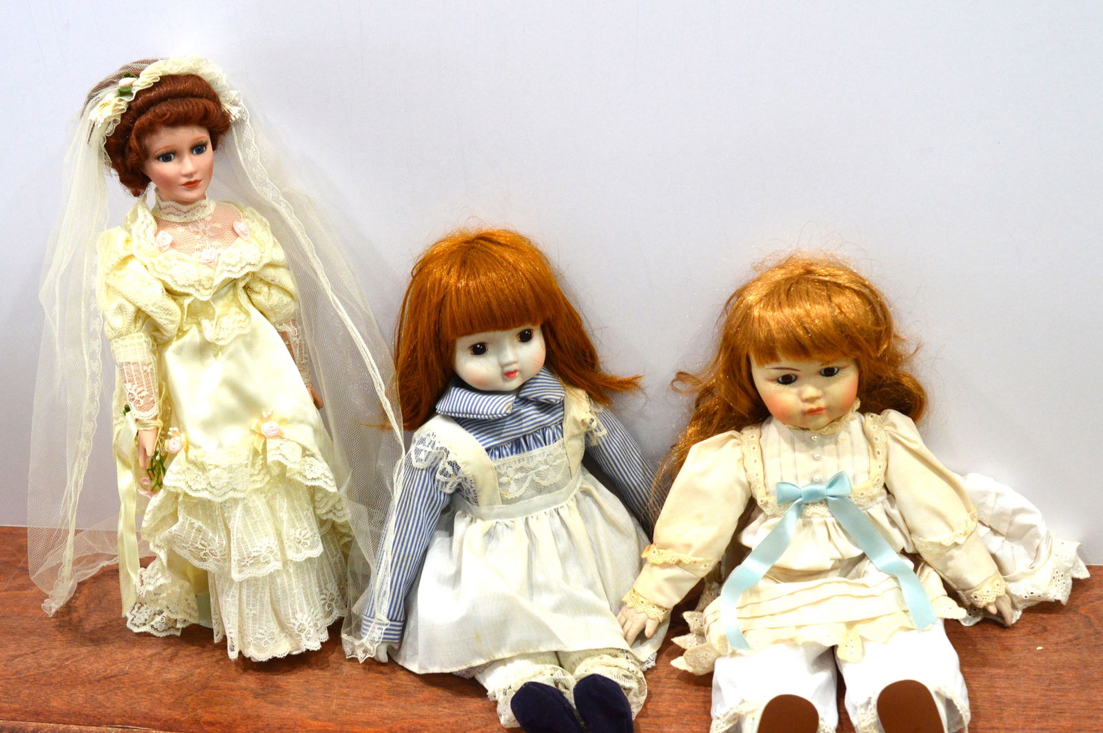 Vintage Dolls: Three vintage dolls from the 1960s. All three have bisque faces and heads. The bridal doll has a stand. One of the baby dolls has a working music box. All are intact. Clothing is removable and can be