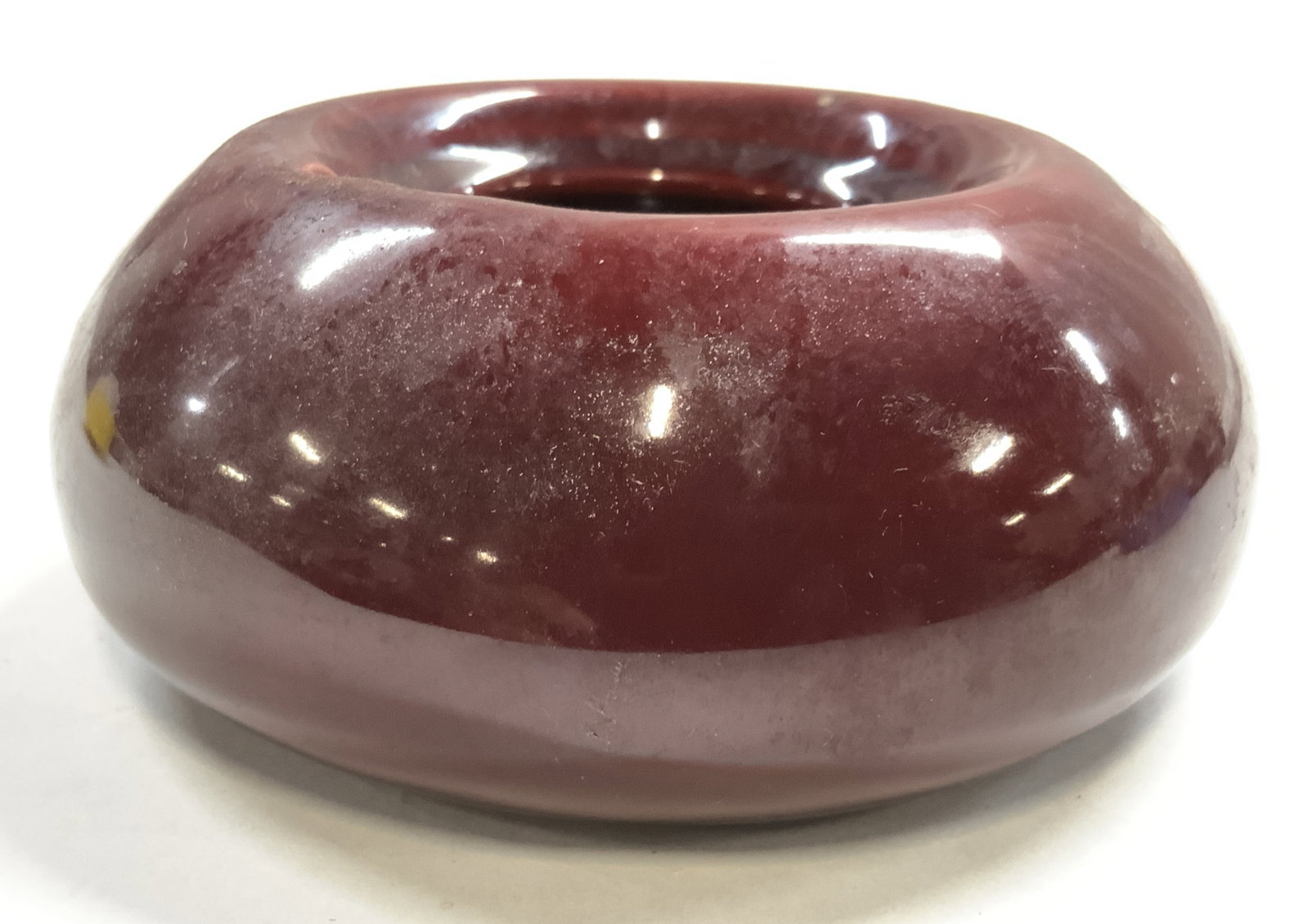 MALIBU MARDEN BY HOLLY DALE Ceramic Ash Tray: Underside is inscribed MALIBU MARDEN BY HOLLY DALE. Piece is blood red toned & ceramic. Ash tray has glazed finish. Piece measures approximately 4.25 inches wide 1.75 inches tall. Ash tray, ceramic as