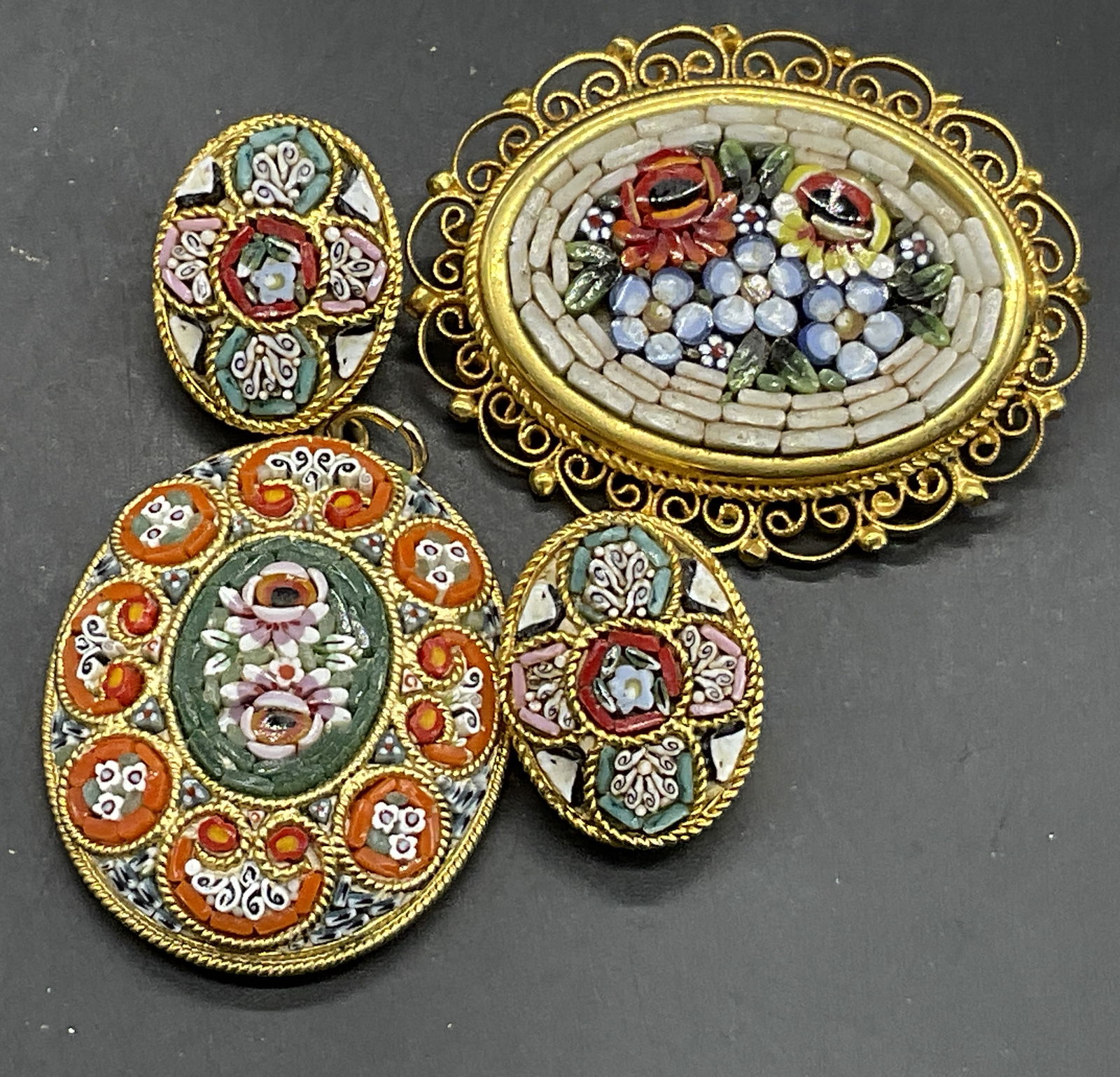 Lot 3 Italian Millefiori Mosaic Earrings, Brooch +: Lot of Three Italian Millefiori Mosaic Earrings, Brooch, and Pendant. Backings to pin and pendant marked ITALY. Clip on backings to the earrings. Gold tone metal hardware with multicolored mosaic deta