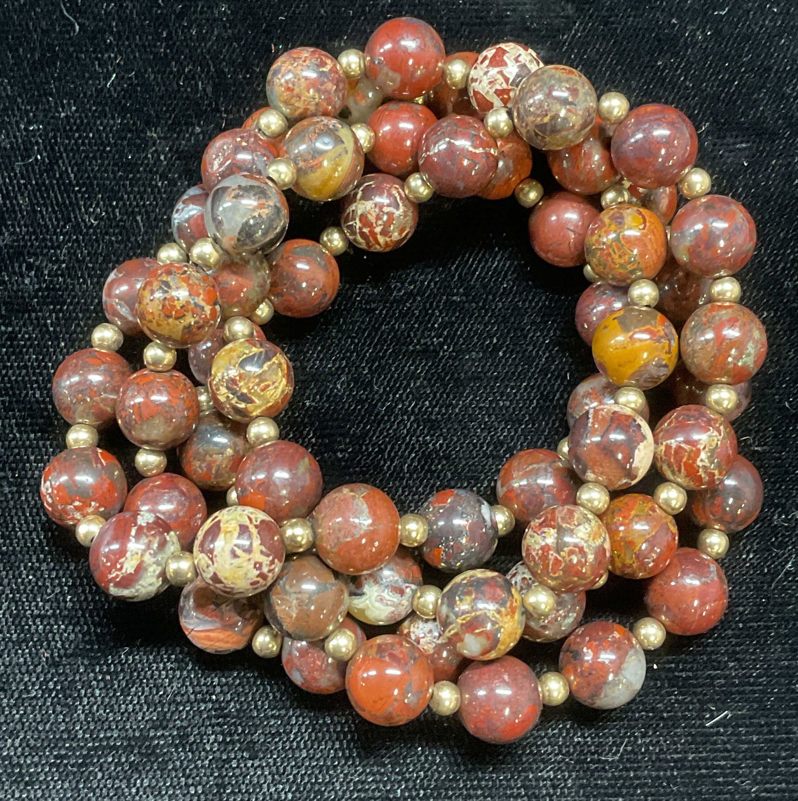 Gold Tone Red Semiprecious Beaded Necklace: Red toned semiprecious stone beaded necklace with gold tone seed beads. Drop length approx 12.5 inches. Some wear including scratching observed. Jewelry, estate jewelry, costume jewelry, cocktail jewe