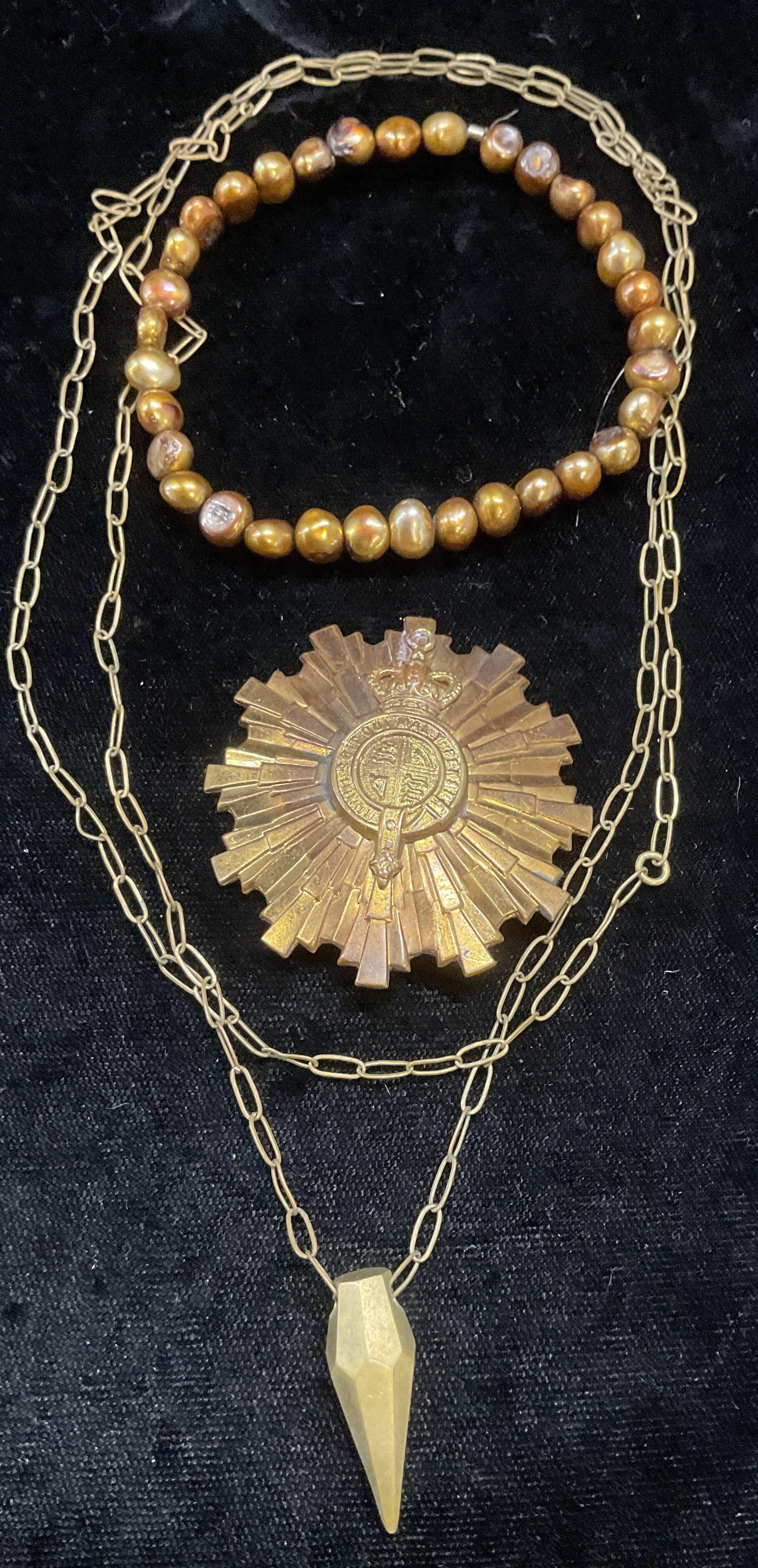 3 Gold Tn Pendant Necklace, Faux Pearl Bracelet+: Lot of 3 jewelry pieces. Gold tone pendant necklace, gold tone French pendant, faux chocolate pearl stretch bracelet. Largest piece drop length approx 16 inches. Some wear to all including scratching 