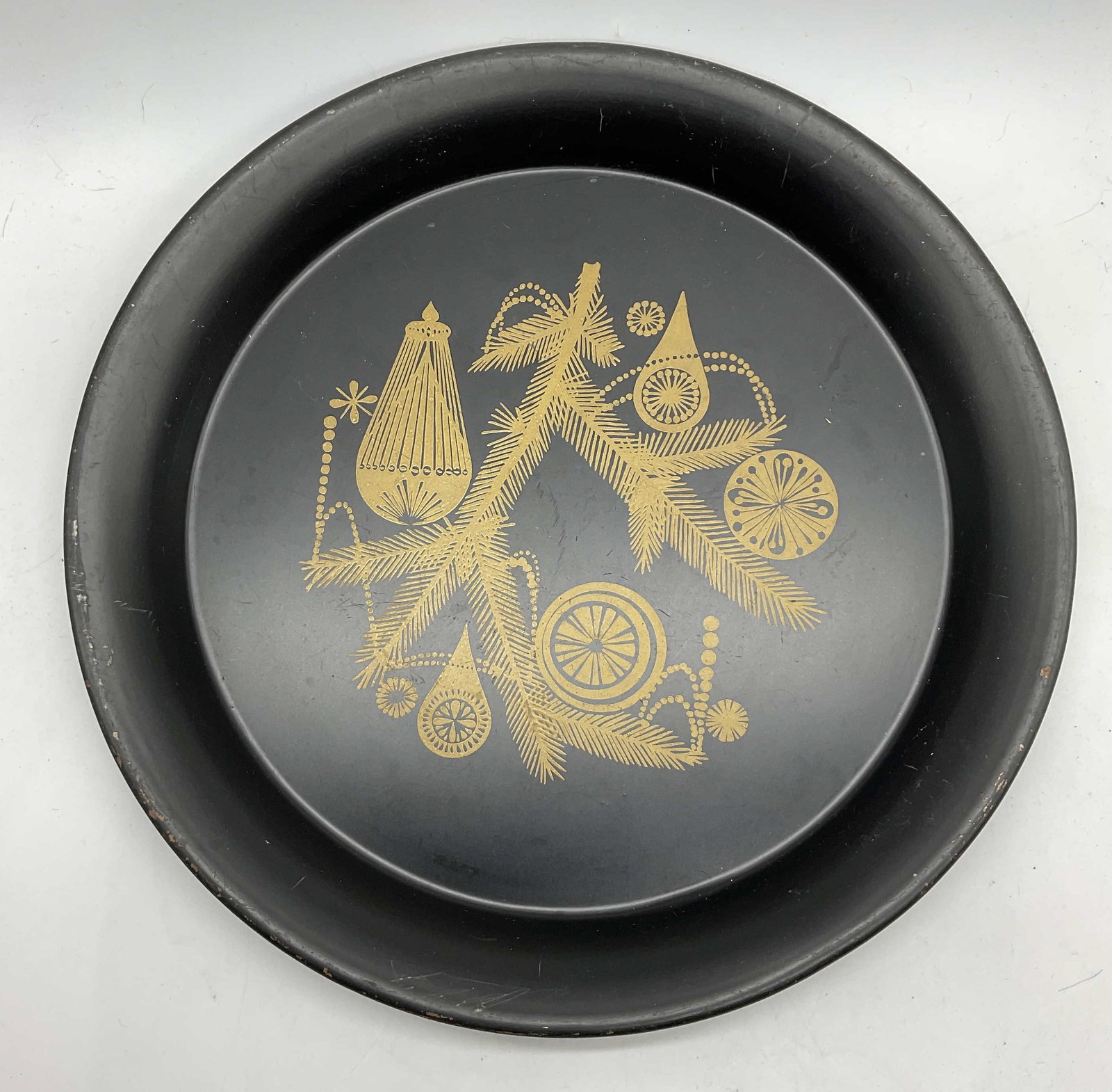 Vintage Black Metal Toleware Circular Tray: Vintage Black Metal Toleware Circular Tray. Gold tone ornament and foliage motif to the center. Measures approx. 12W x 1H in. Surface wear, residue, and losses present. home decor, home accents, homew