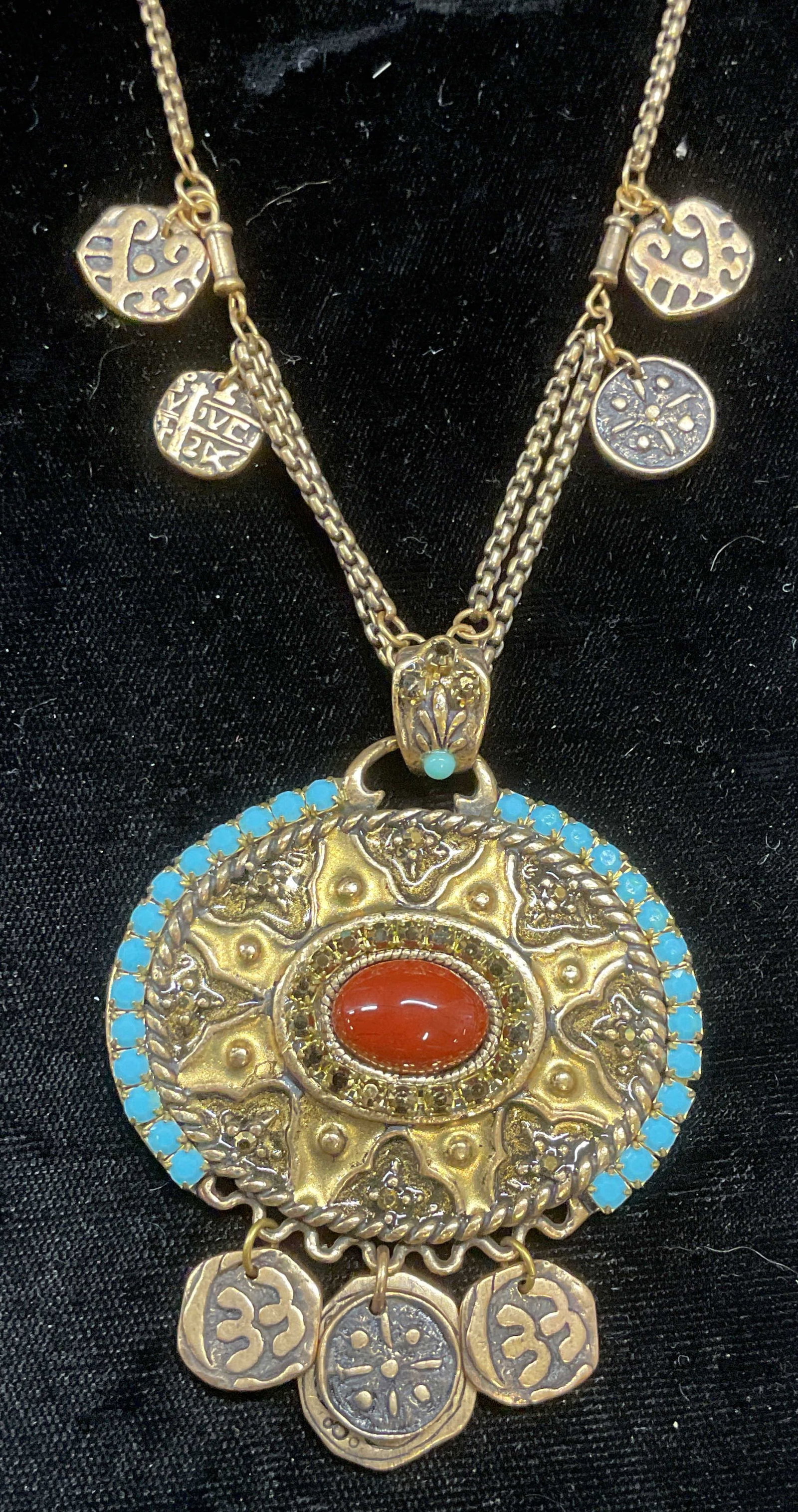 Chicos Gold Tone Crystal Pendant Necklace: Chicos gold tone pendant necklace with faux turquoise and faux red cabochon decoration. Signed on hang tag. Drop length approx 8.5 inches. Pendant approx 2.5 x 2 inches. Some wear including scratching