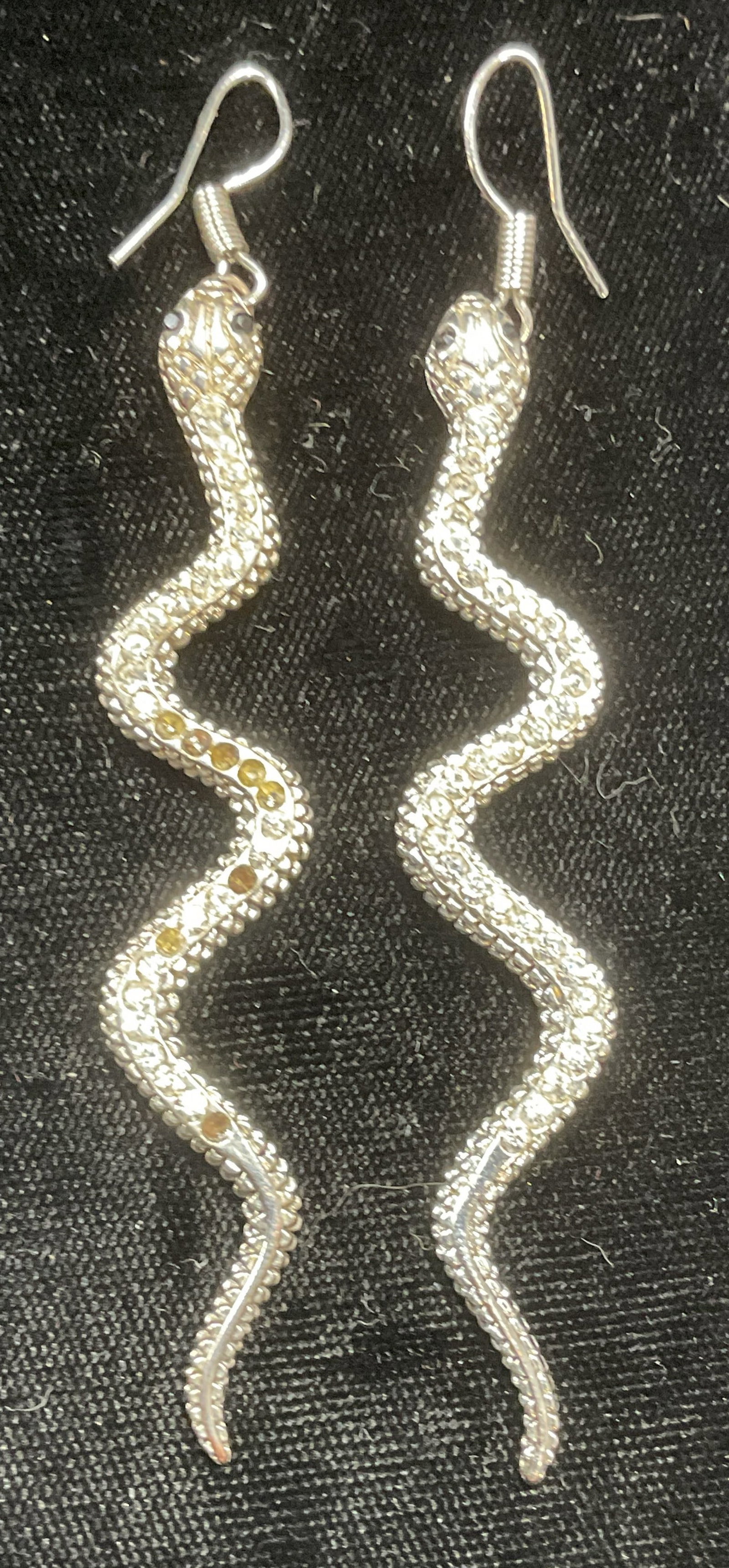 Silver Tone Crystal Snake Earrings, 3 In L: Silver tone snake motif dangle earrings with crystal. Measure approx 3 inches long. Some wear including scratching observed. Some crystals need replacement. Jewelry, estate jewelry, costume jewelry, c