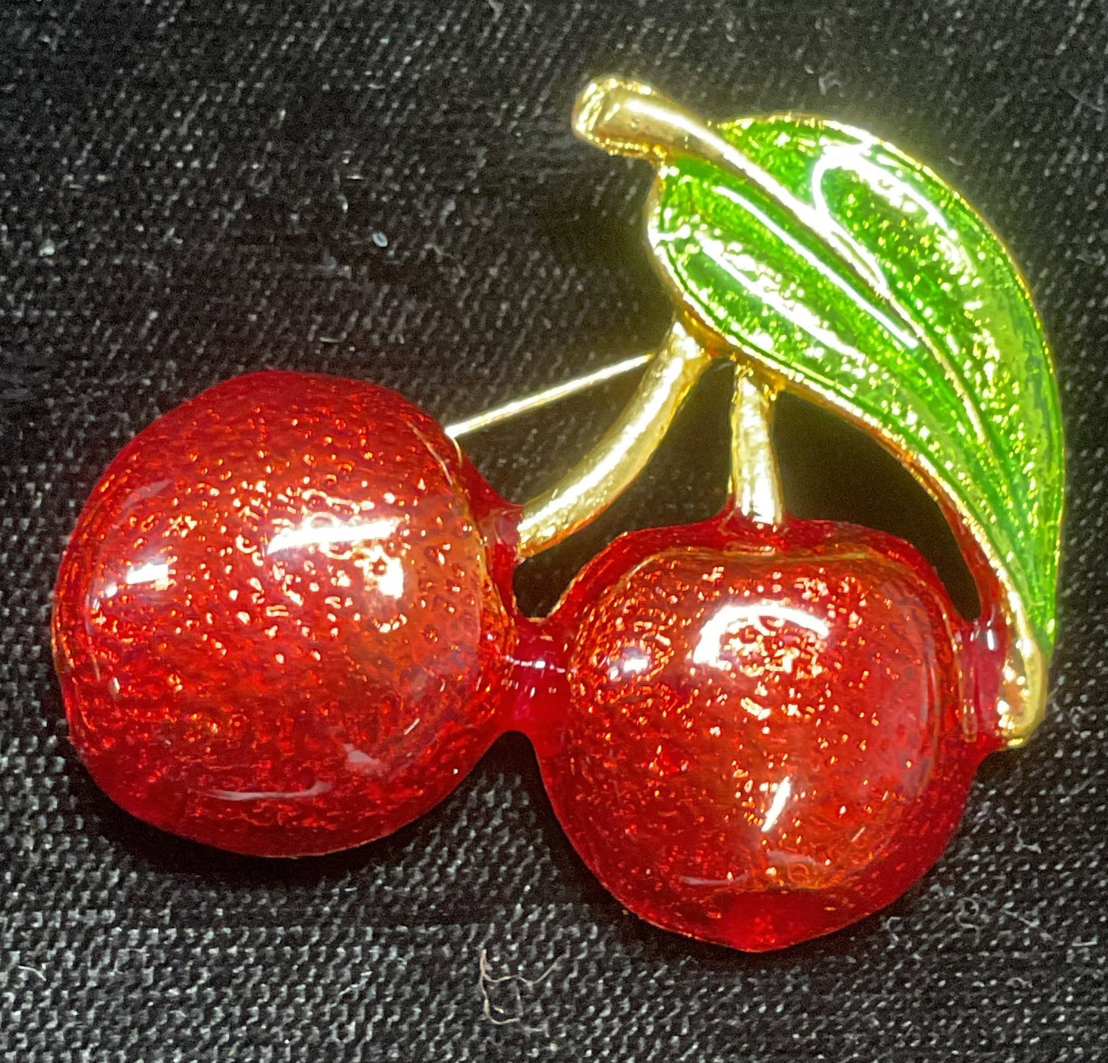 Gold Tone Red Enamel Cherry Brooch: Gold tone cherry motif brooch with red and green enamel. Measures approx 1.5 x 1 5/8 inches. Some wear including scratching observed. Jewelry, estate jewelry, costume jewelry, cocktail jewelry, fashio