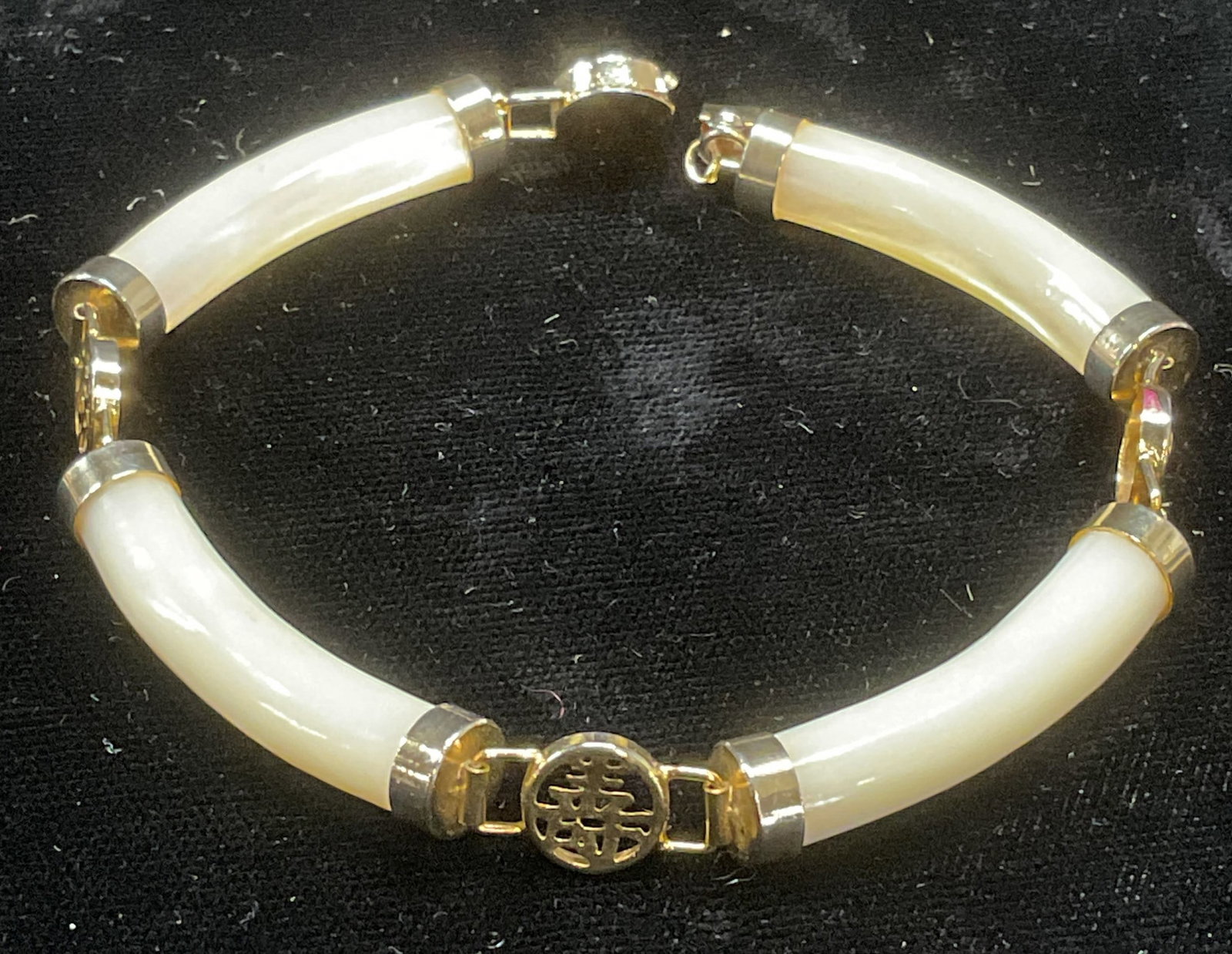 Vtg Chinese Gold Tn Mother of Pearl Bracelet: Vintage bracelet with gold tone Chinese character motif panels. Links appear to be mother of pearl, possibly glass. Measures approx 7.5 inches long. Some wear including scratching. Jewelry, costume je