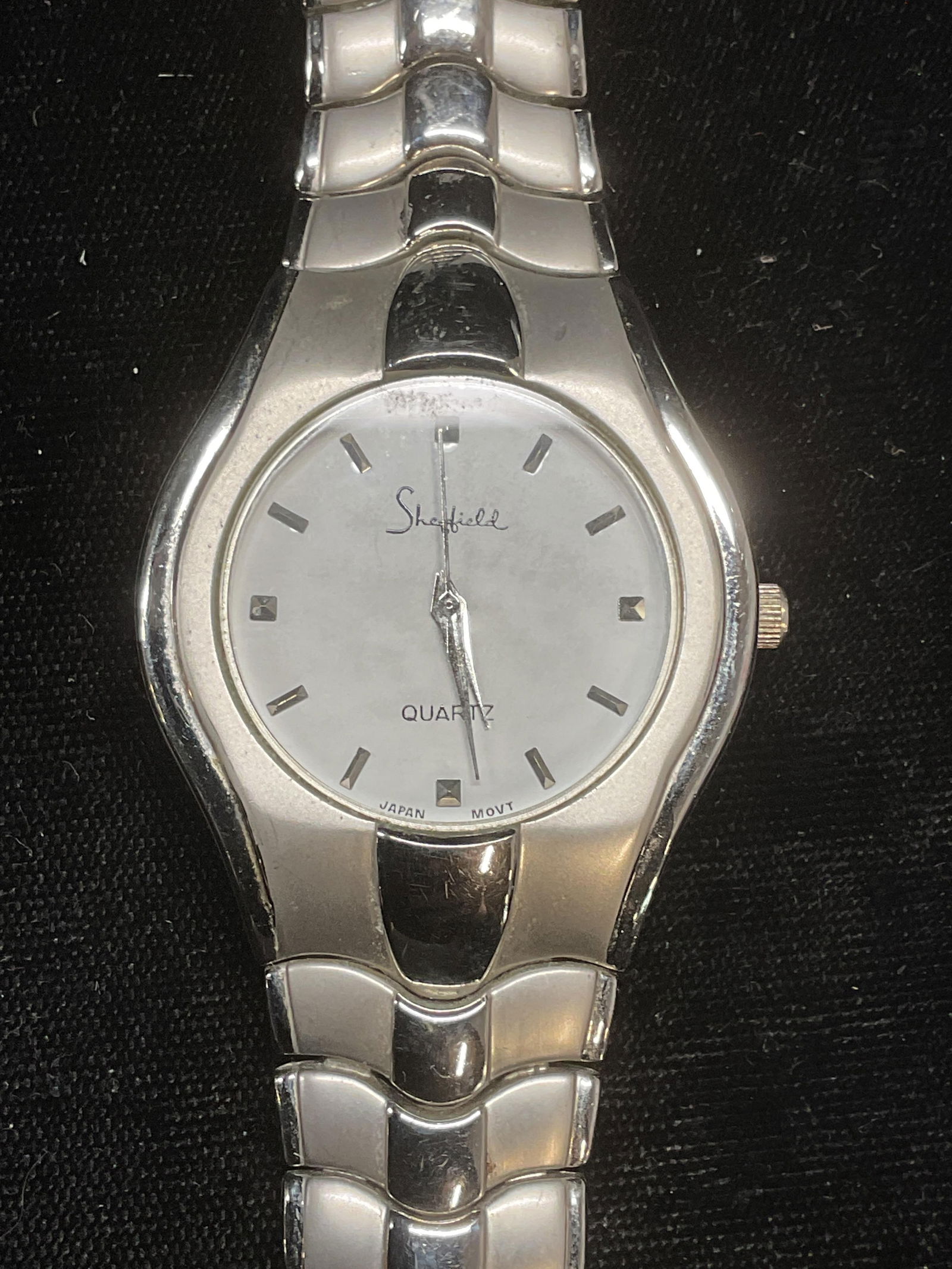 Sheffield Silver Tone Watch: Sheffield duo silver tone watch. Signed on dial. Stainless steel case. Measures approx 7.5 inches long. Not tested for function. Some wear including scratching. Jewelry, costume jewelry, estate jewelr