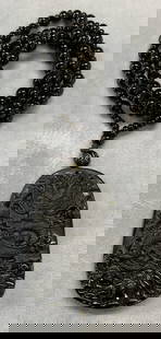 Asian Black Dragon Pendant Necklace: Asian black beaded pendant necklace with dragon motif pendant. Appears to be obsidian. Drop length approx. 11.5 inches. Pendant measures approx. 2.5 x 1.5 inches. Some surface wear including scratchin