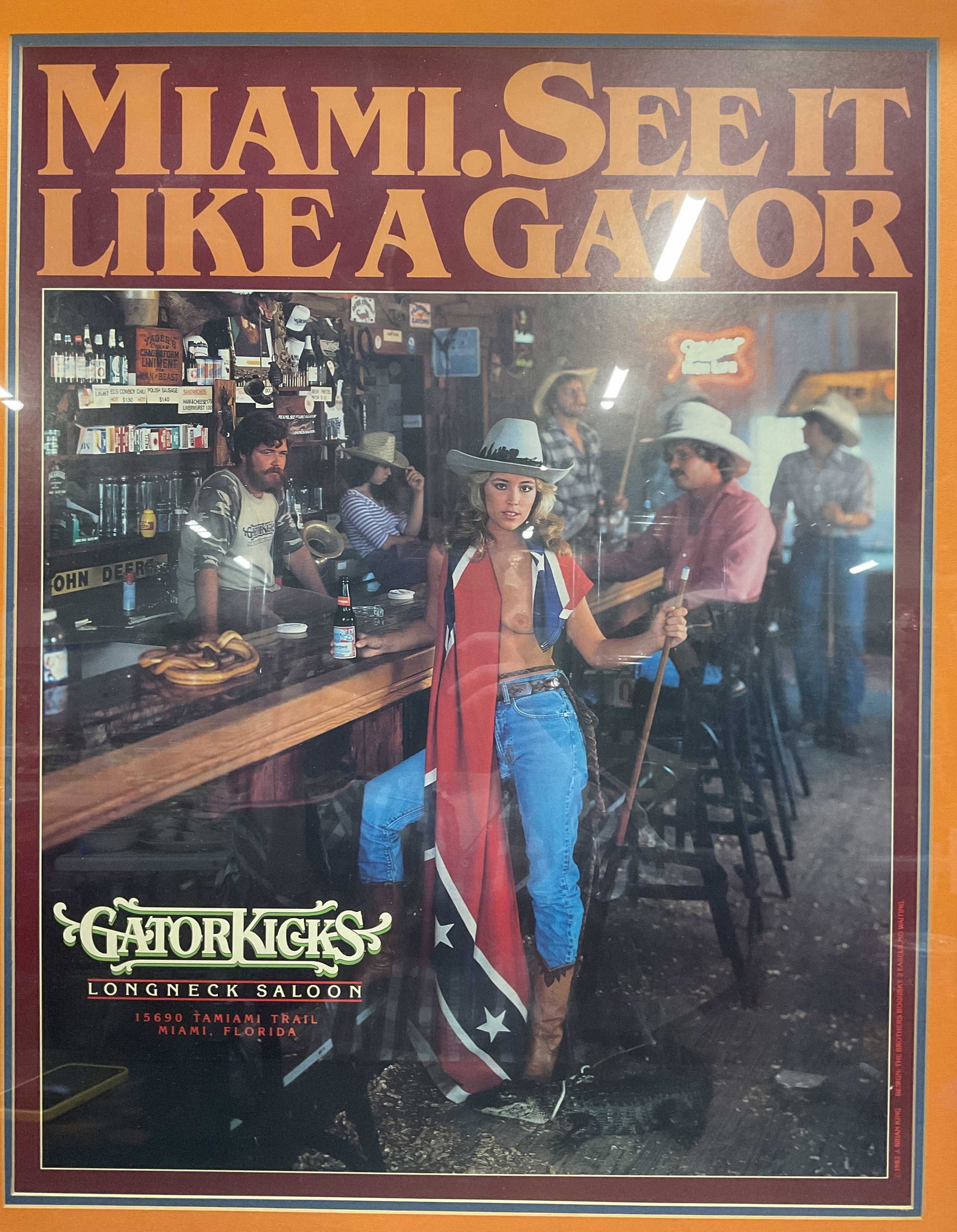 1982 Longneck Saloon Miami Florida Advert Poster: Framed Gator Kicks Longneck Saloon, Miami, Florida promotional poster. Design by The Brothers Bogusky. Text reads Miami. See It Like A Gator. Gator Kicks Longneck Saloon. Interior bar scene with tople