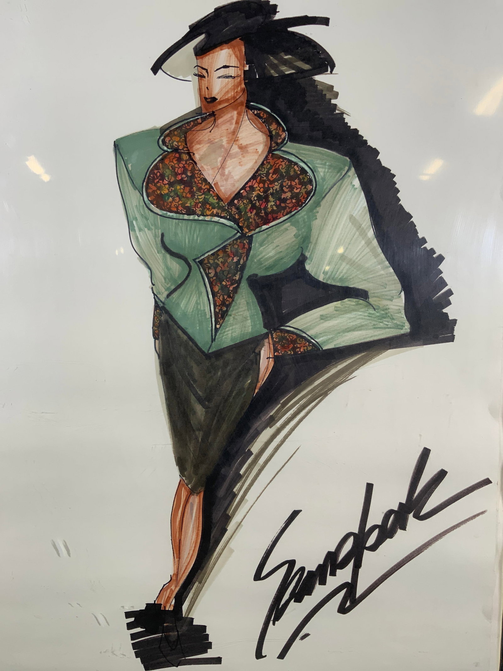 Framed & Signed Fashion Model Woman Illustration: Marker illustration on paper. Subject depicts a fashion model in a black pencil skirt and green blazer with a floral lapel. Signed on lower right corner. Signature is illegible. Framed in a composite 