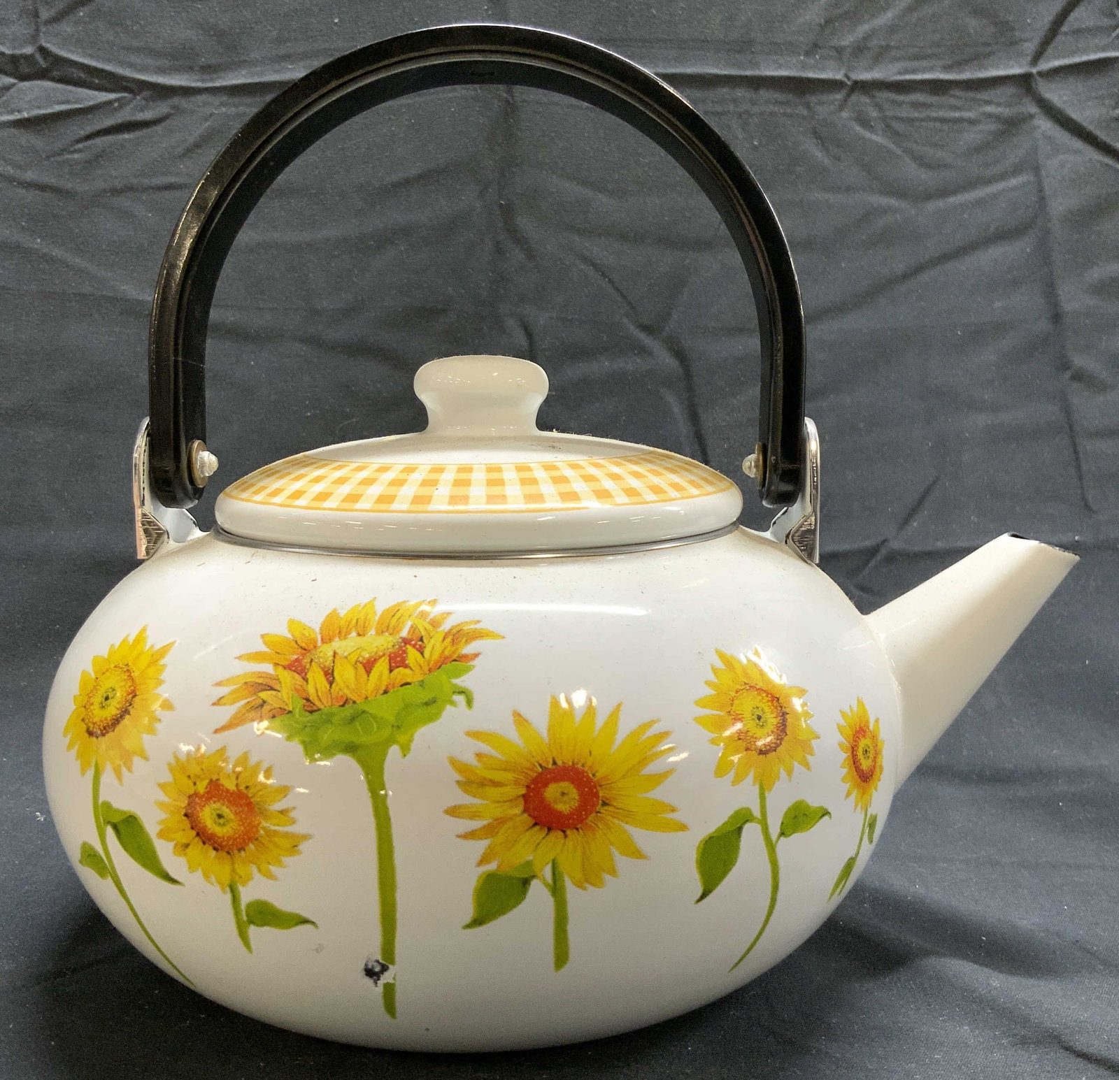 Vintage Enameled Tea Kettle W Lid & Handle: Tea kettle is vintage. Piece is white with sunflower & bee Detail. Tea kettle includes lid & black toned arched handle. Piece is enameled. Tea kettle measures approximately 9 inches deep 8.25 inches t