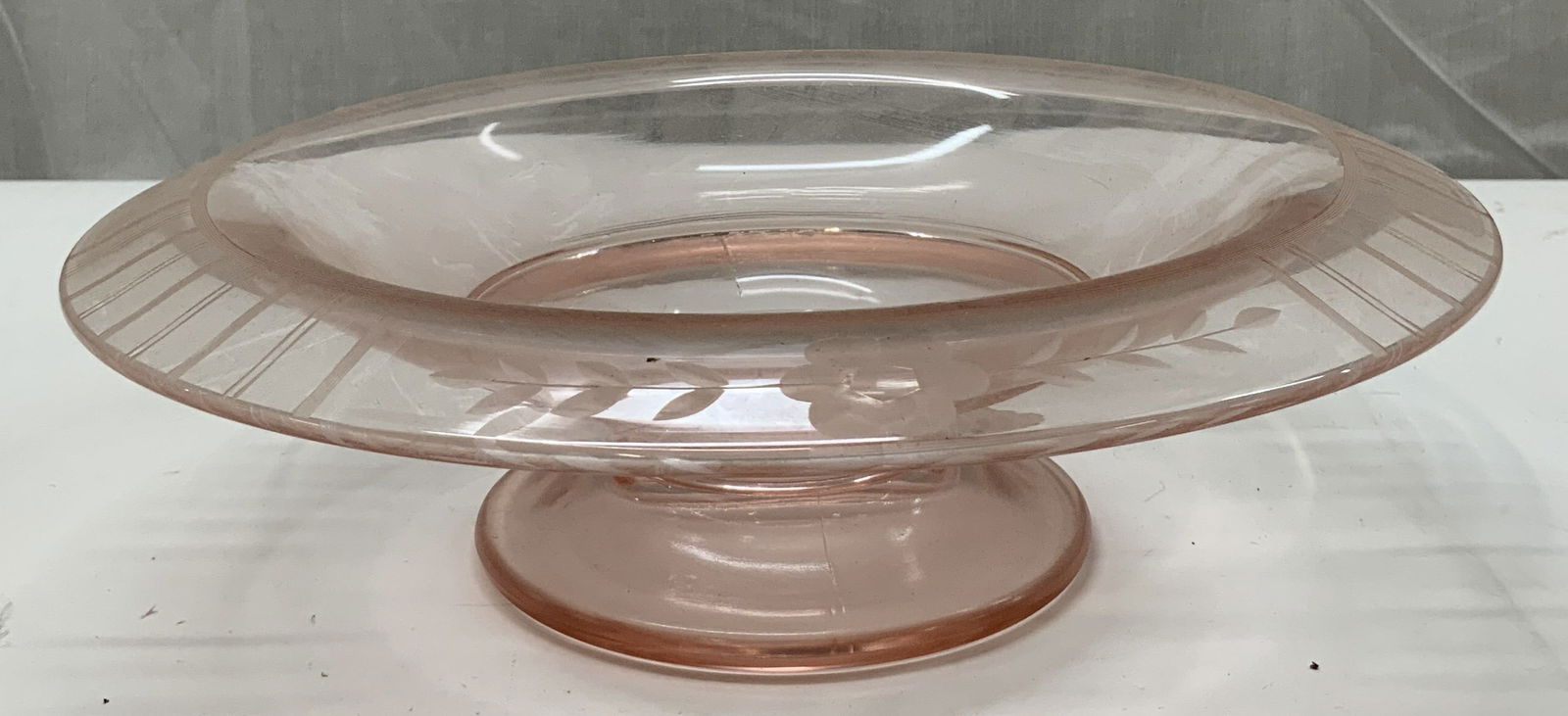 Vintage Pink Depression Footed Glass Bowl: Vintage Pink Depression Footed Glass Bowl. Has a unique etched border design on the brim end, consisting of a floral stem, and horizontal lines. No visible signature. No noticeable markings or chippin