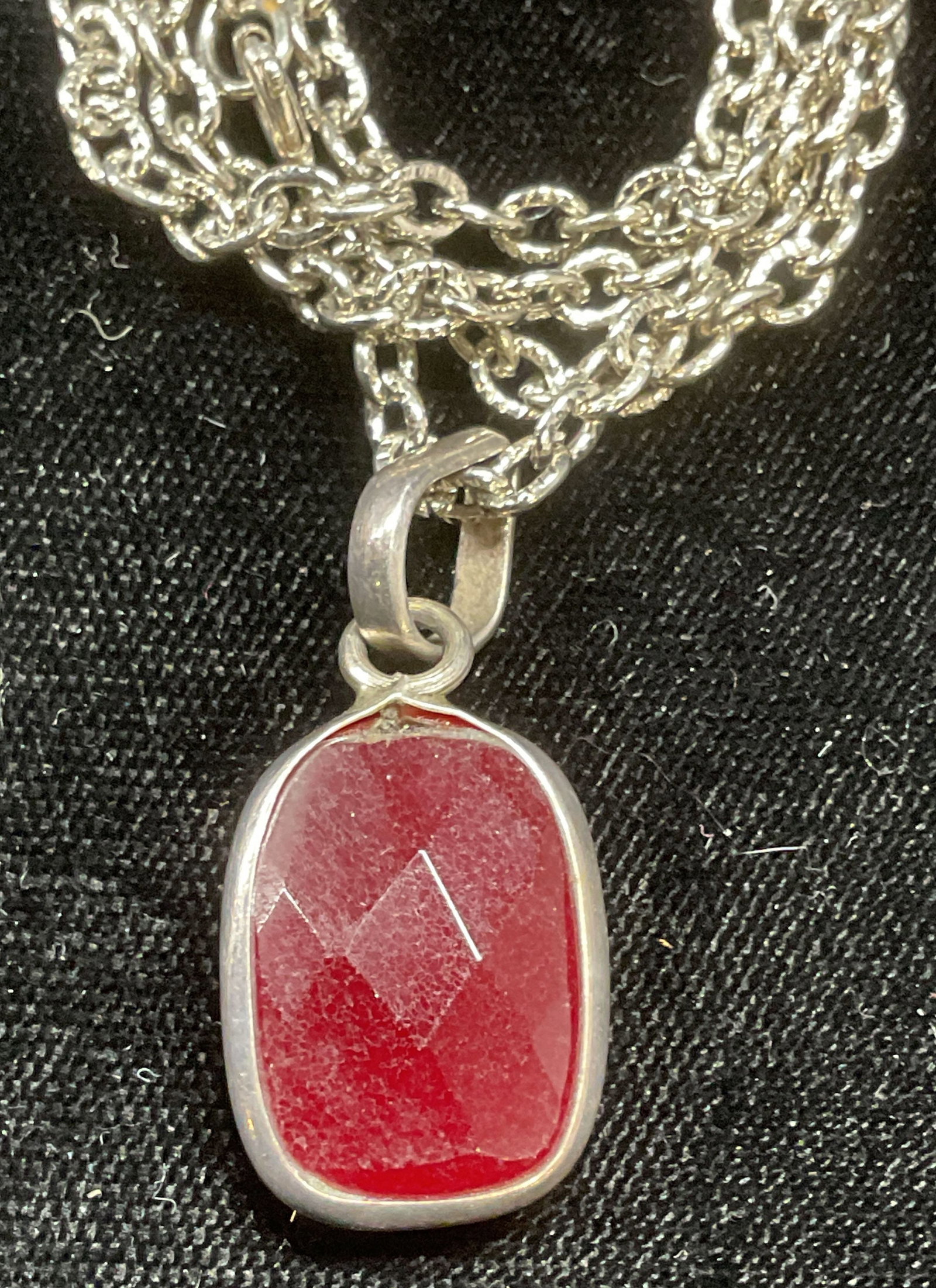 Sterling Silver Red Semiprecious Pendant Necklace: Sterling silver chain necklace with sterling and red semiprecious stone pendant. Marked sterling. Drop length approx 12 inches. Total weight 12.6 grams. Some wear including scratching observed. Jewelr