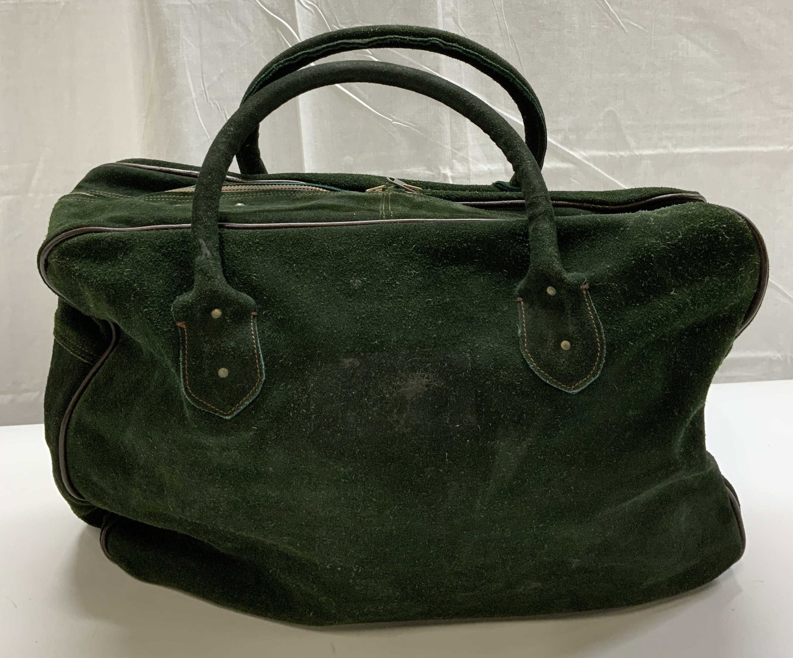 Vintage Green Suede Luggage bag Poland: Vintage Green Suede Luggage bag. Green suede luggage bag with straps and zippers. Bottom of luggage bag has metal studs. Has unique zipper, closes only halfway for each zipper. Made in Poland. Measure