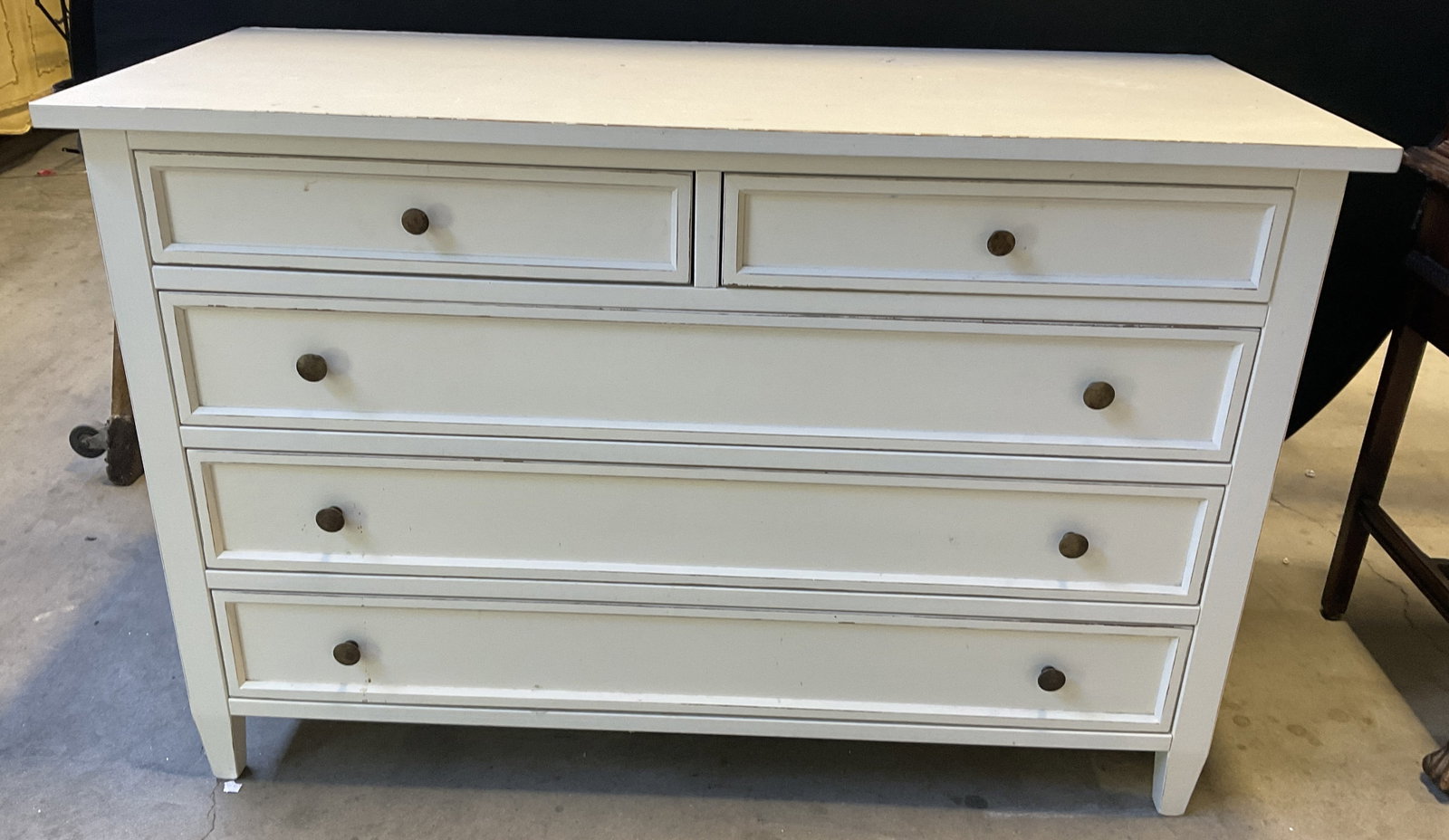 BUYING & DESIGN ITALY White Five Drawer Dresser: A painted white wooden dresser with five drawers. Metal pulls to the drawers. Measures approx. 55W x 36H x 23D in. Discoloration, chipping, surface wear, and losses to finish. Some drawers and drawer 