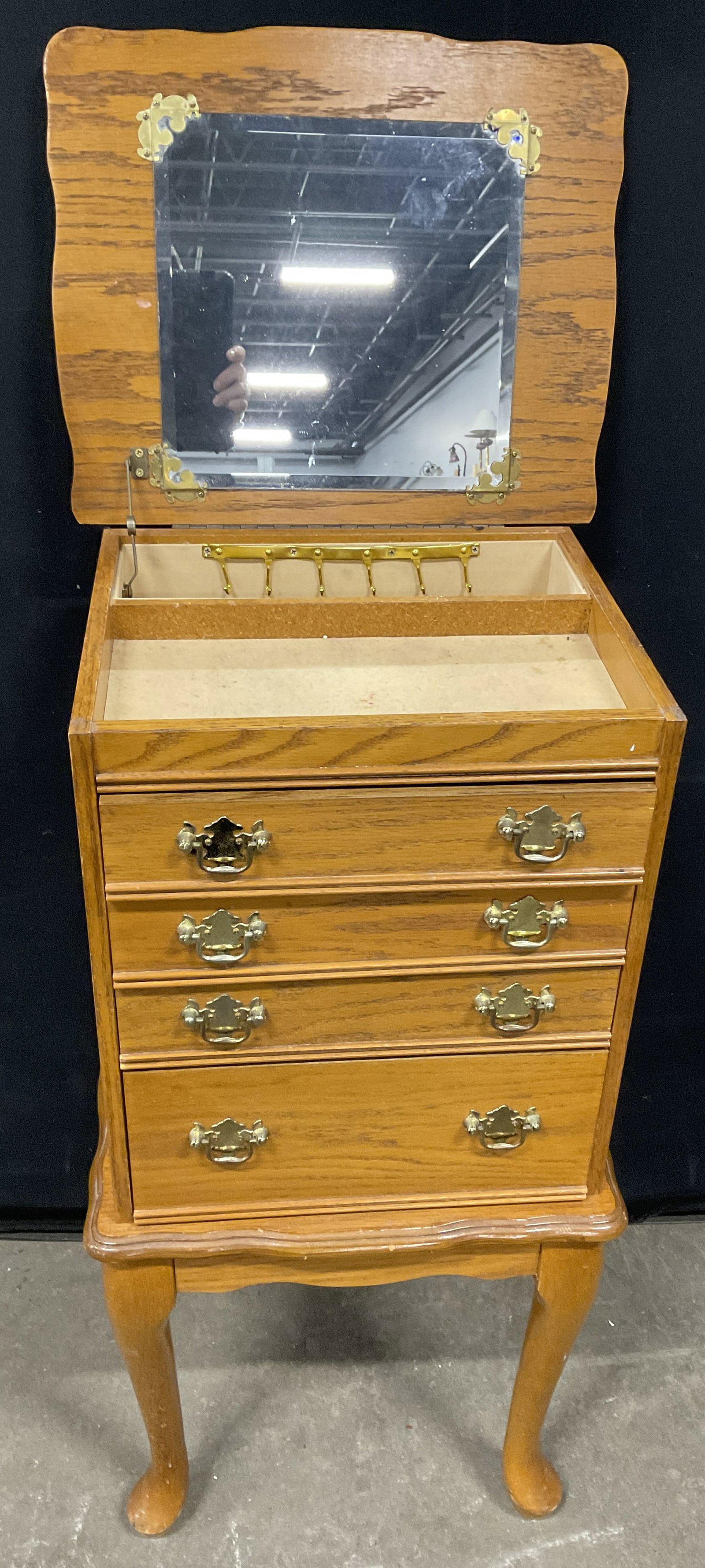 Vintage Wooden Standing Jewelry Armoire: Vintage Wooden Standing Jewelry Armoire. Light hued wood finish with drawer toned metal drawer pulls. Top opens with metal hinge hardware. Various compartments for storing jewelry. Measures approx. 32