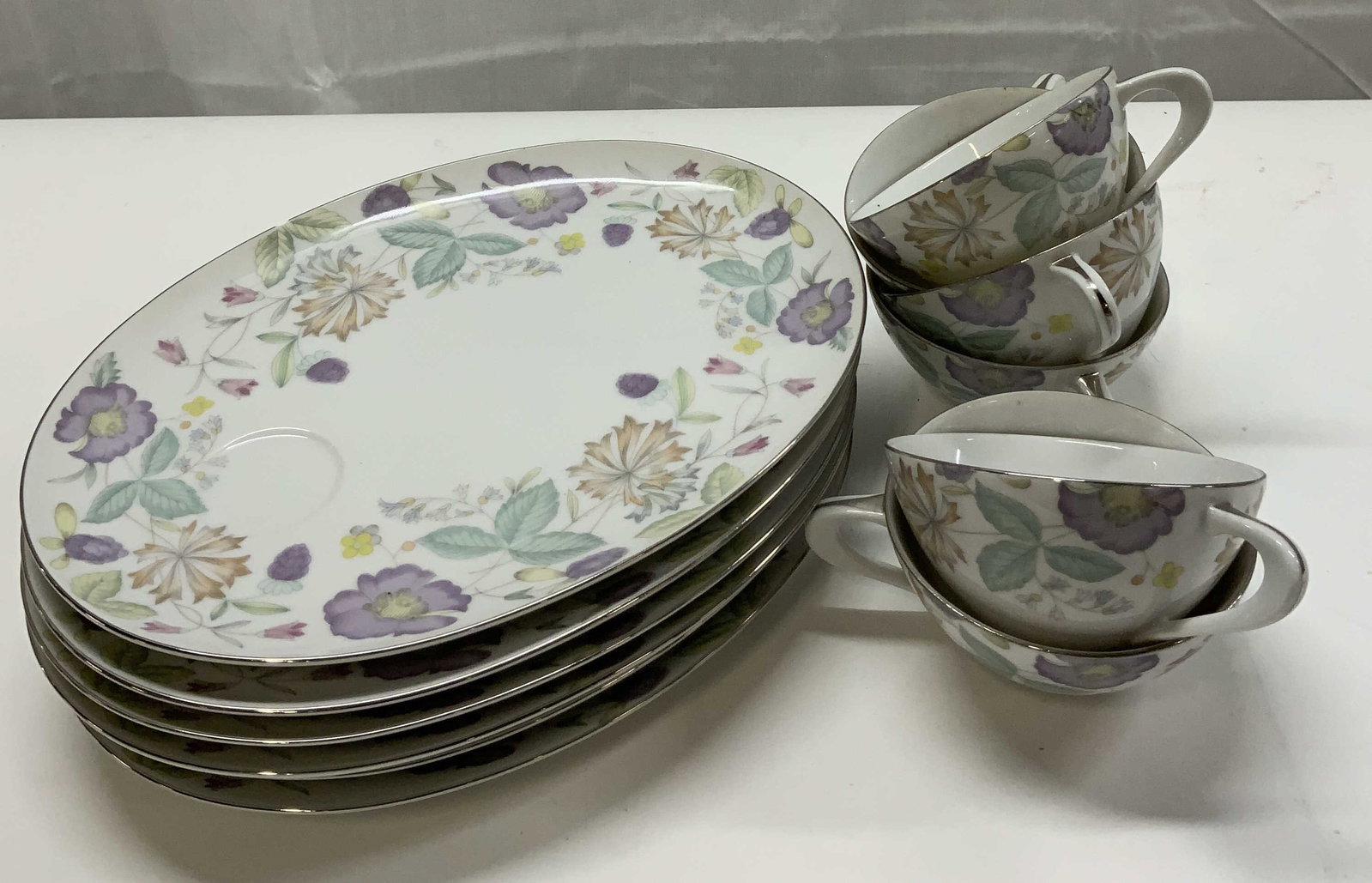 Group Lot Sango Japan Fantasia Floral Platter &Cups: Group Lot Sango Japan Fantasia Floral Platter & Cups. 6 porcelain oval platter plates, they have a decorative floral design with purple berries. 6 cups with the same floral design. Underside reads Fin