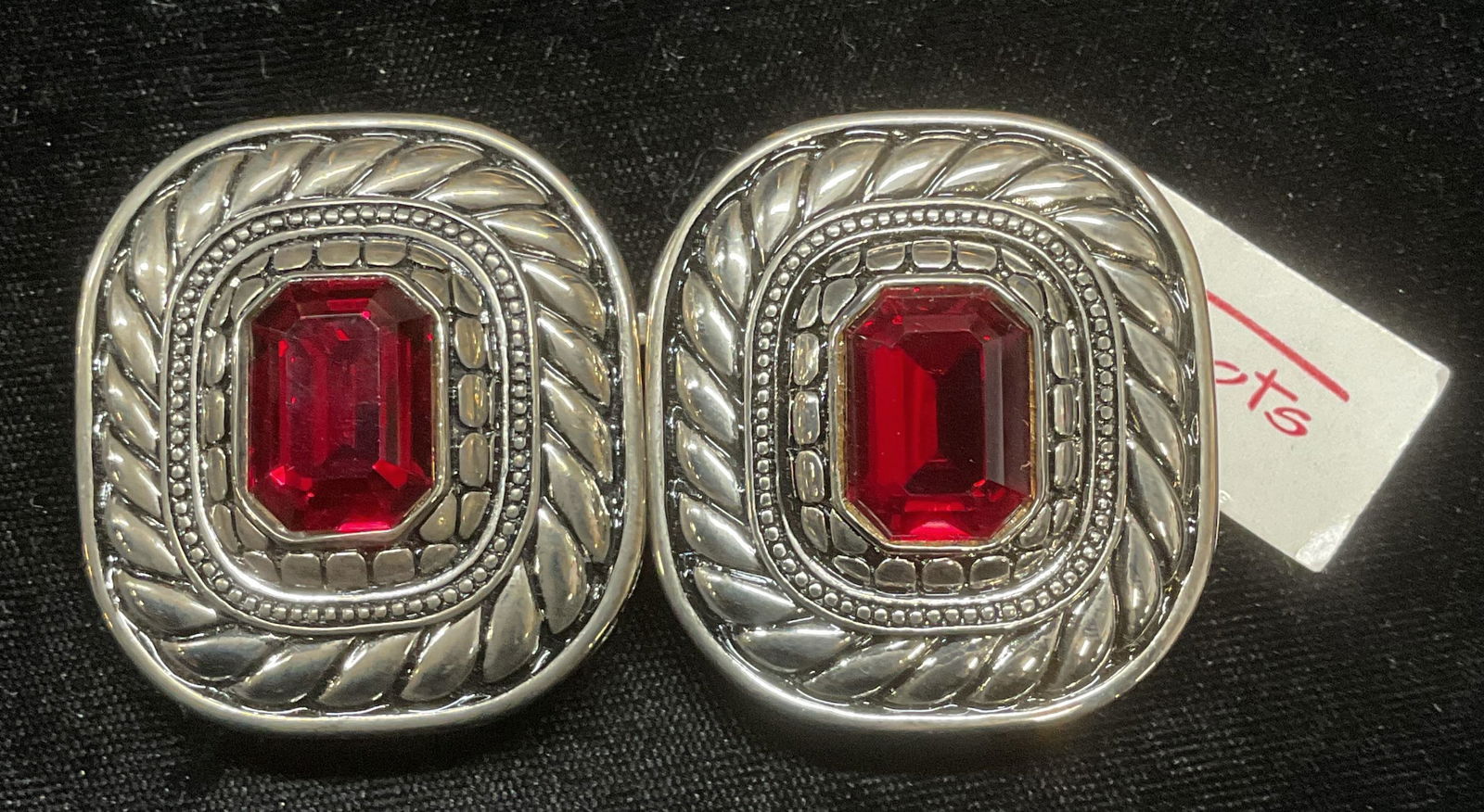 Paquette Silver Tn Red Crystal Belt Buckle NWT: Paquette two piece silver tone cable motif belt buckle with red crystal. Signed on underside. Measure approx 1.75 x 1.5 inches each. New with tag. Some wear including scratching observed. Paquette, Pa
