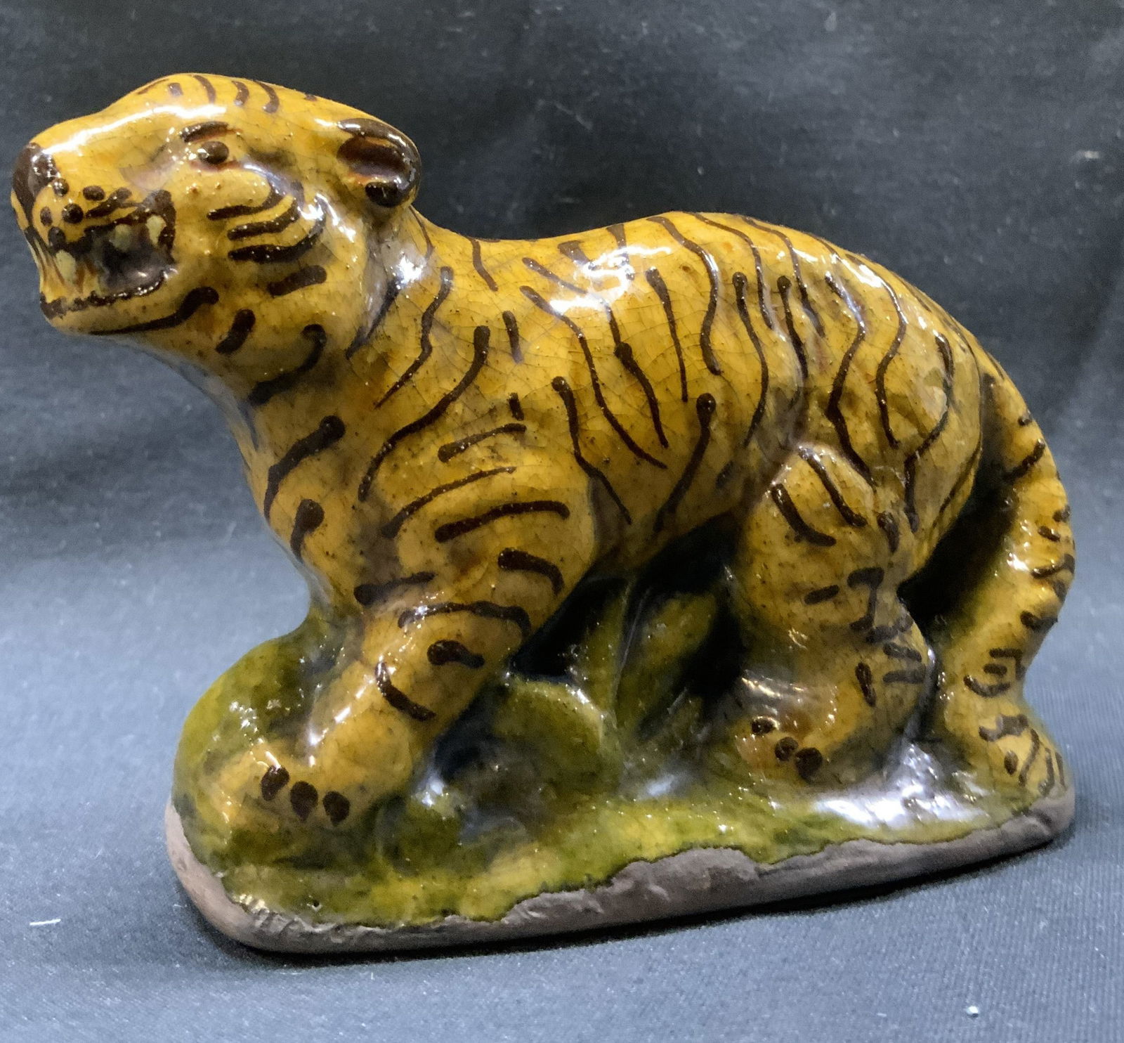 Mary Spellmire Shooner Redware Pottery Tiger: Mary Spellmire Shooner Redware Pottery Tiger Tiger figurine that has brown stripes and a yellow body. Tiger is standing in a green base. Underside reads, Mary Spellmire Shooner. This figurine is made