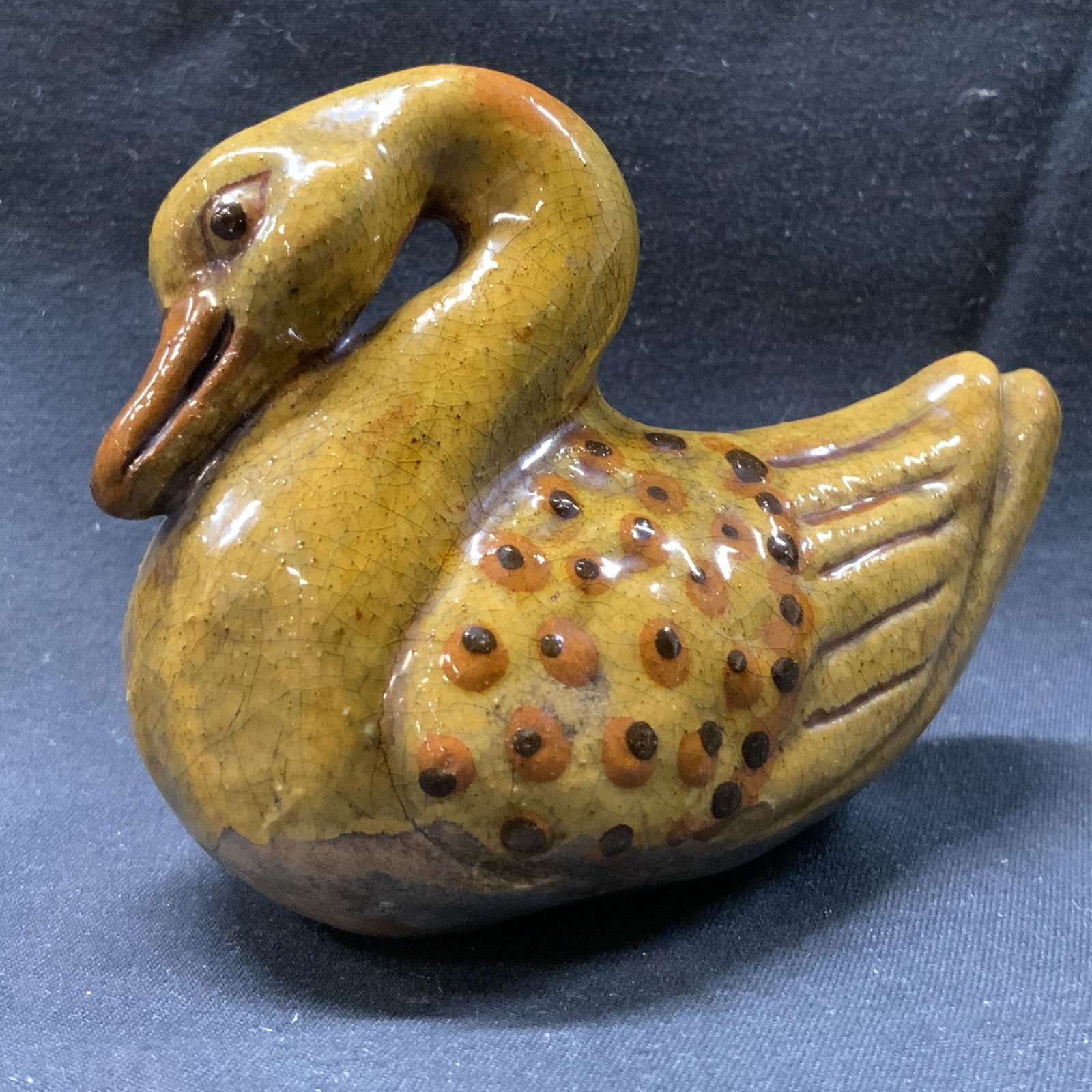 Mary Spellmire Shooner Redware Pottery Swan: Mary Spellmire Shooner Redware Pottery Swan Swan figurine that has a yellow body & orange/brown speckled details. Has a curved neck with an orange beak. Underside reads, Mary Spellmire Shooner. This f