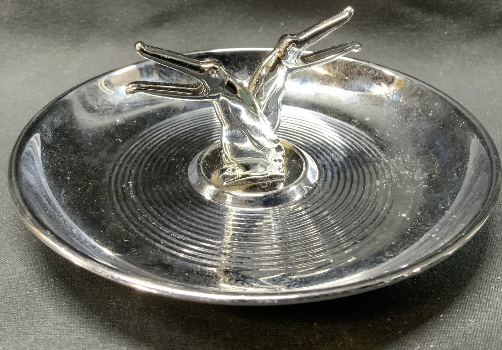 Vntg Chrome Pincherette Diecaster USA Ashtray: Vintage Chrome Pincherette Ashtray Ashtray with two toucan birds in the middle. Toucan birds have their beaks open. Has a very distinctive design. Underside reads, by Diecasters Inc. Ridgefield NJ. Pi