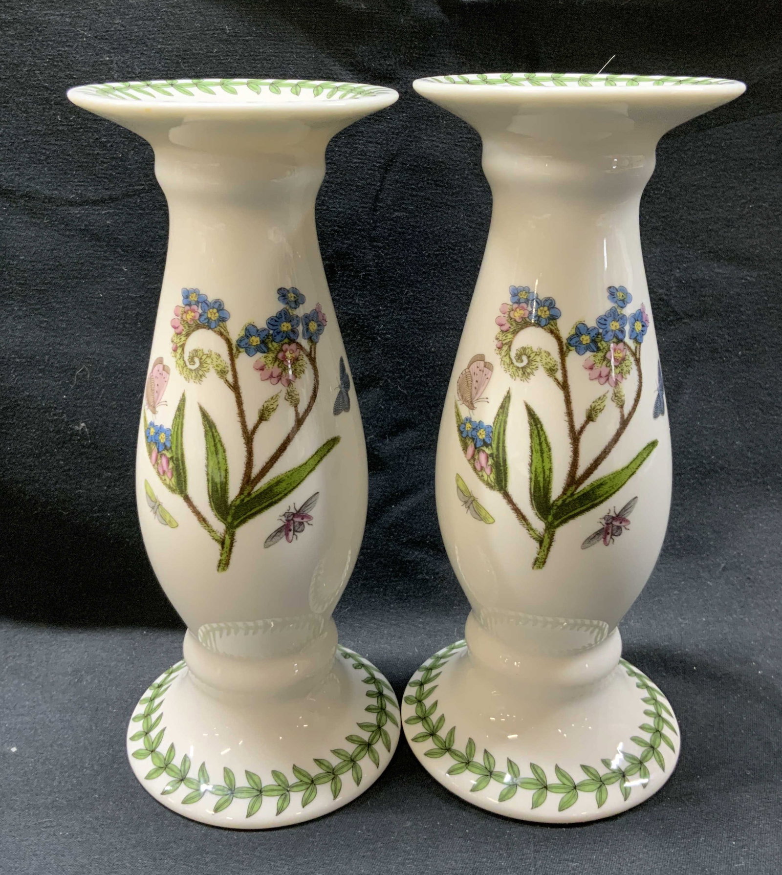 Lot 2 Portmeirion Botanic Garden Candlesticks: Lot 2 Portmeirion Botanic Garden Candlesticks Porcelain Candlesticks with a floral & butterfly design in the middle. Has a distinctive leaf pattern on the top and foot of the candlesticks. Underside r