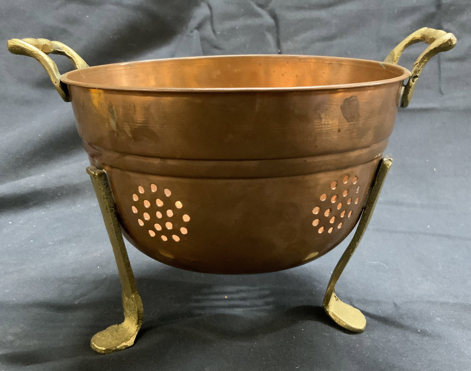 Vntg Copper Colander W Brass Handles & Feet: Colander is copper. Piece is vintage. Colander has gold toned brass handles and 3 feet. Piece measures approximately 7.25 inches wide 6 inches deep 5.25 inches tall. Colander, copper colander, vintage