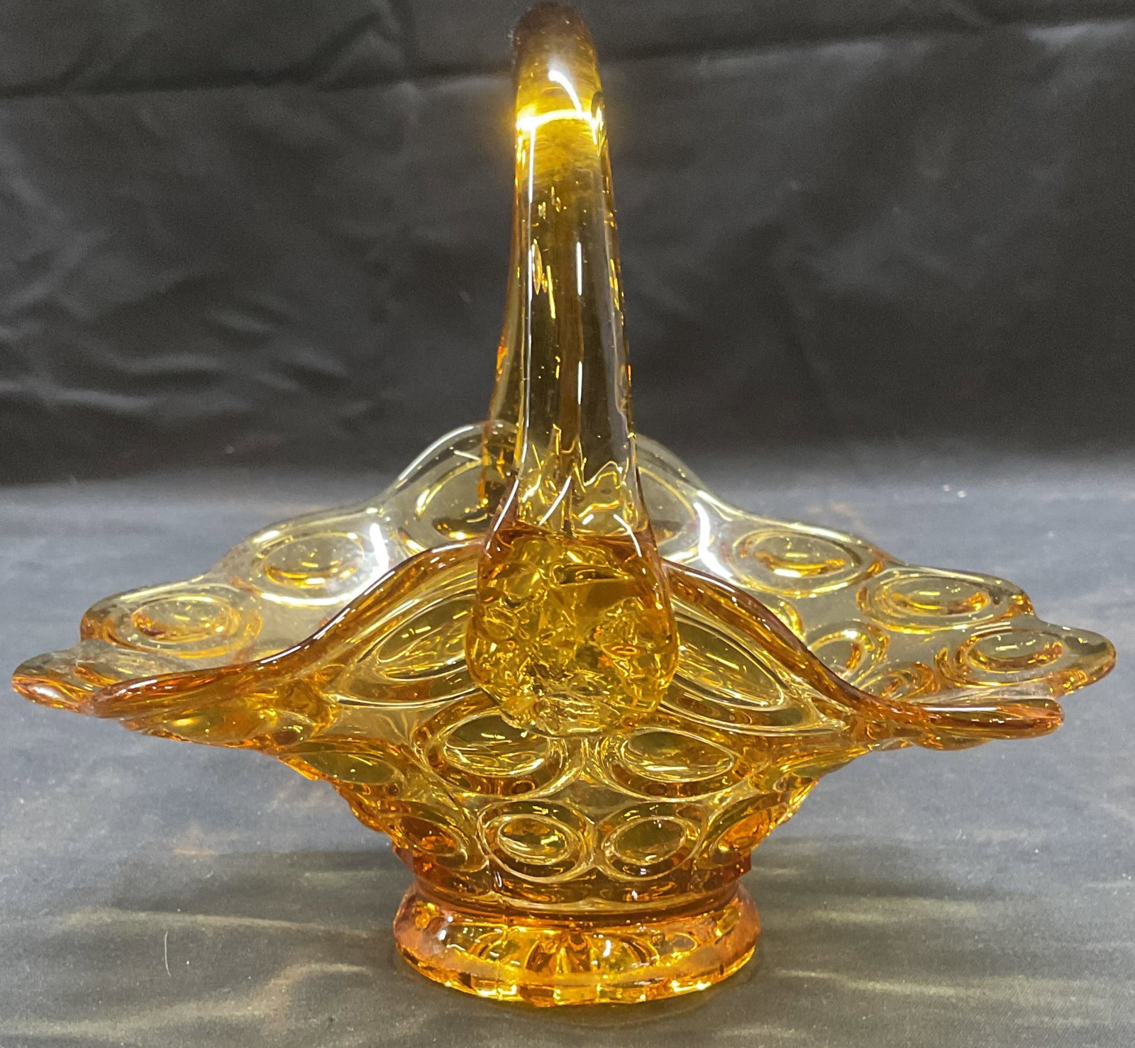 Vintage Amber Glass Scalloped Basket: Vintage Amber blown and mold pressed glass basket with circular motif and scalloped rim. Measures approx 6.5 x 5.25 x 5.75 inches. Some wear including scratching observed. Amber glass, amber glass bas