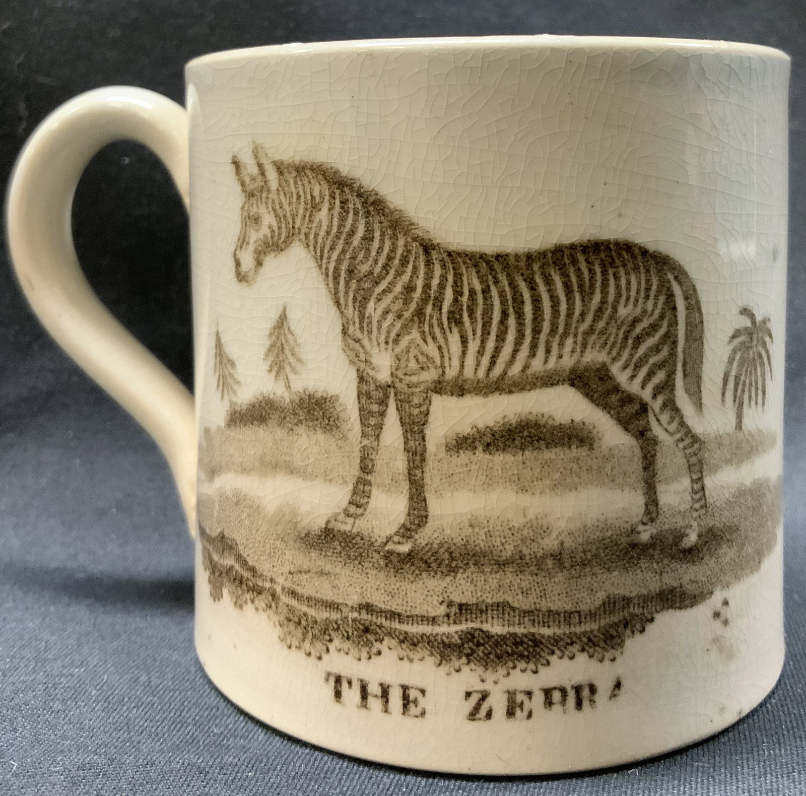 Davenport Porcelain The Zebra Cup: Davenport Porcelain The Zebra Cup. Porcelain cup with images of a zebra & a house with dogs running in the background. Underside marked & signed. Noticeable crazing consistent with age, use & exposure