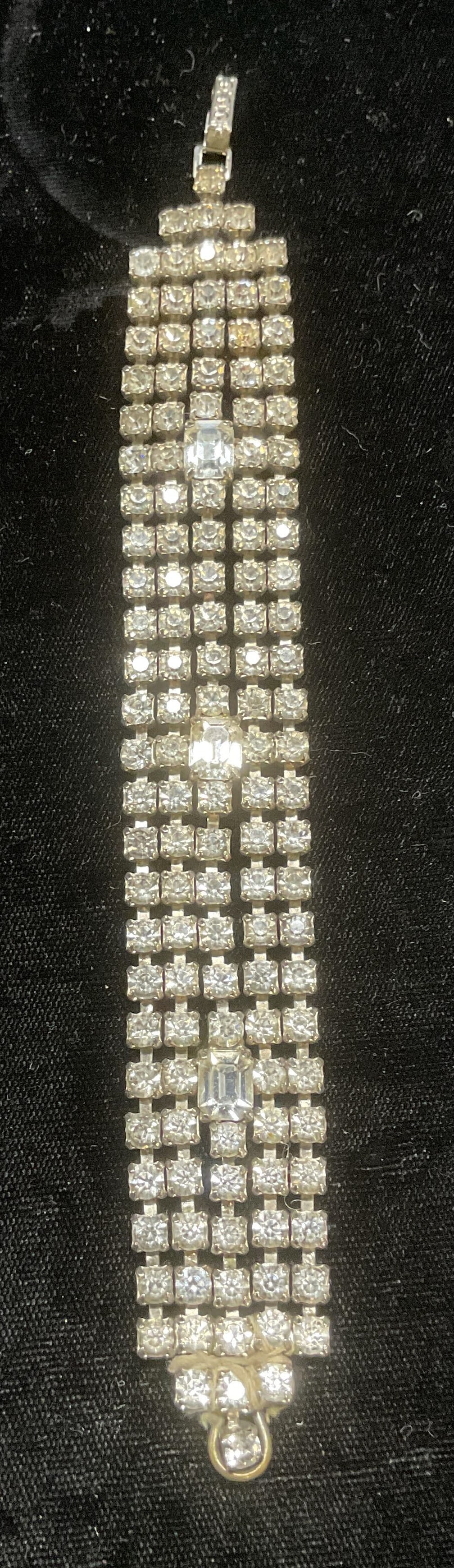 Vtg La Rel Silver Tone Crystal Bracelet: Vintage La Rel silver tone crystal decorated bracelet. Signed on clasp. Measures approx 6.25 inches long. Some wear including scratching observed. String tied around bracelet, may be a repair, not rem