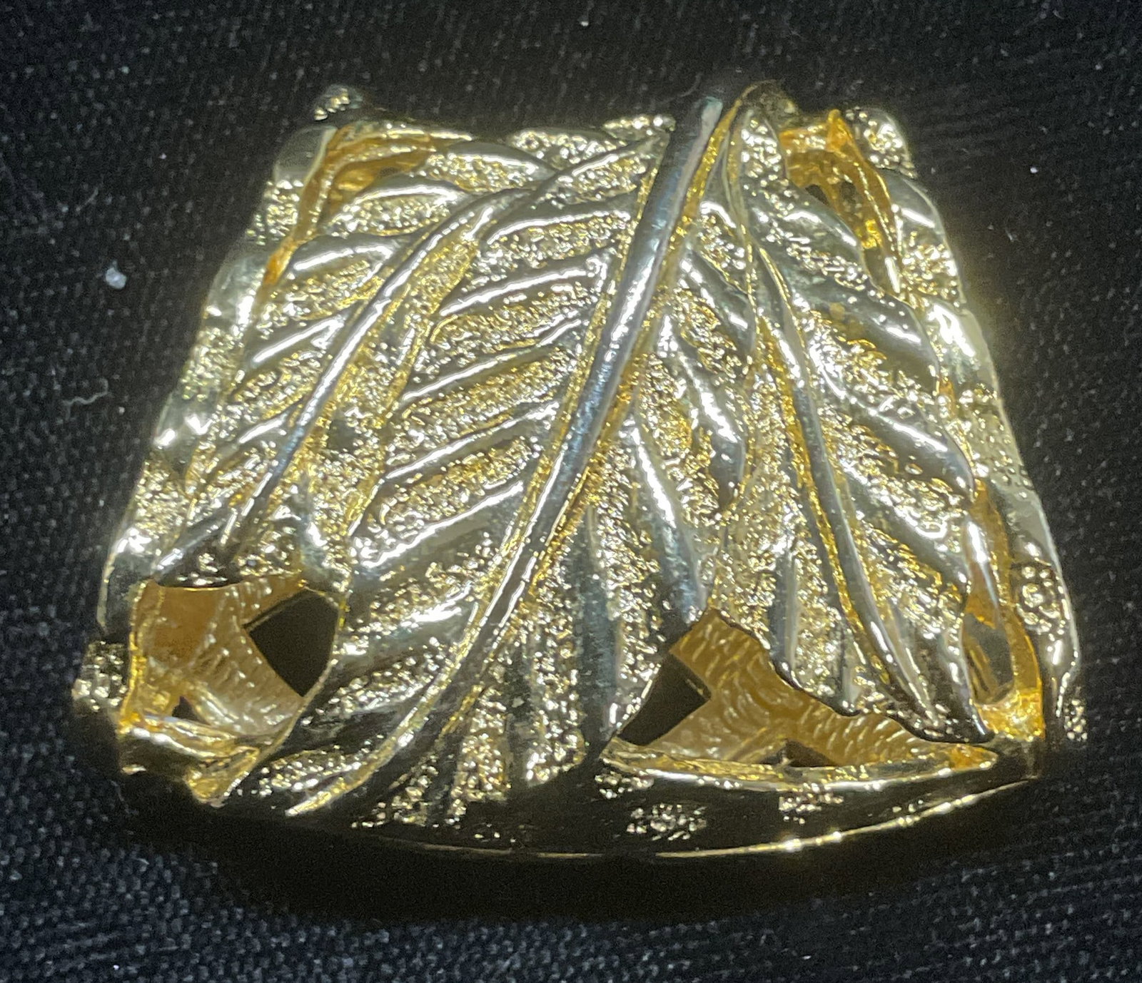 Gold Tone Leaf Tube Pendant: Gold tone tube pendant with pierced leaf motif. Measures approx 1.25 x 1.5 inches. Some wear including scratching observed. Jewelry, estate jewelry, costume jewelry, cocktail jewelry, fashion jewelry,