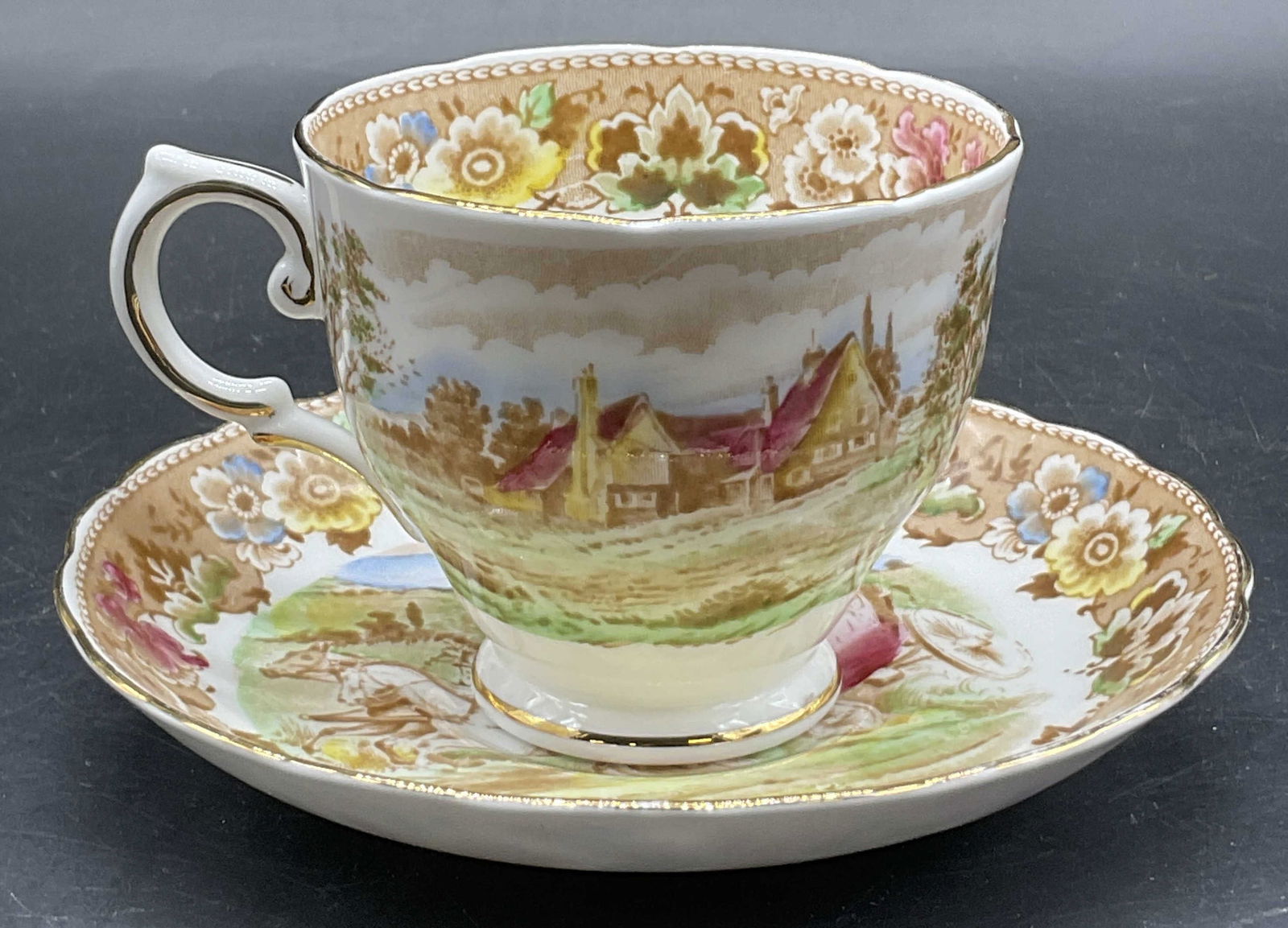 TUSCAN ENGLISH FINE BONE CHINA Teacup & Saucer: TUSCAN ENGLISH FINE BONE CHINA Teacup & Saucer. Pieces feature multicolored horse and buggy motifs. Undersides are signed TUSCAN ENGLISH FINE BONE CHINA, MADE IN ENGLAND. Saucer measures approx. 5.5W