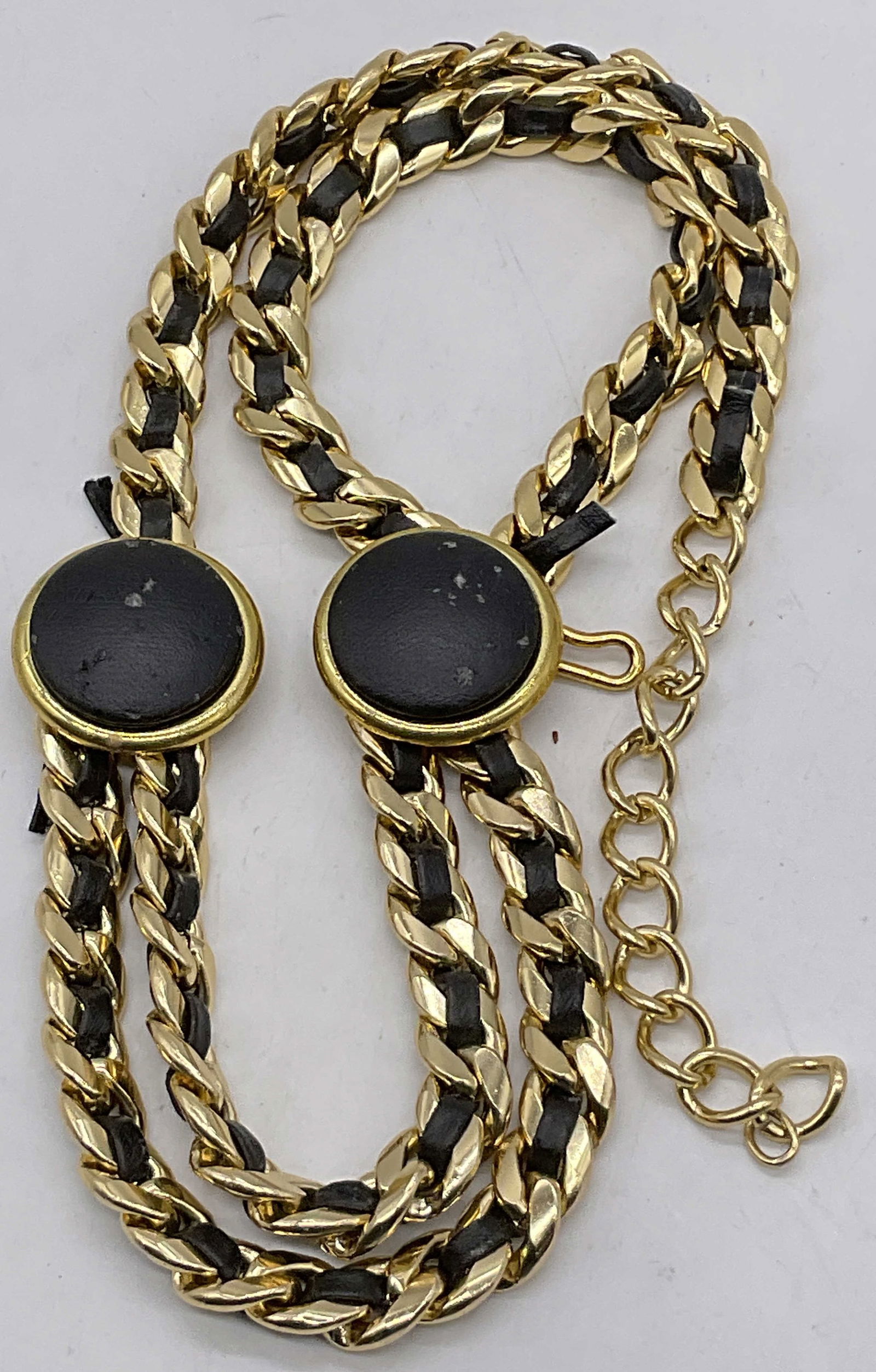 Vintage Gold Tone Metal & Black Leather Chain Belt: Vintage Gold Tone Metal & Black Leather Chain Belt. Belt length approx. 35 inches. Hook closure. Black material appears to be leather or leather style material. Losses, surface wear, and discoloration