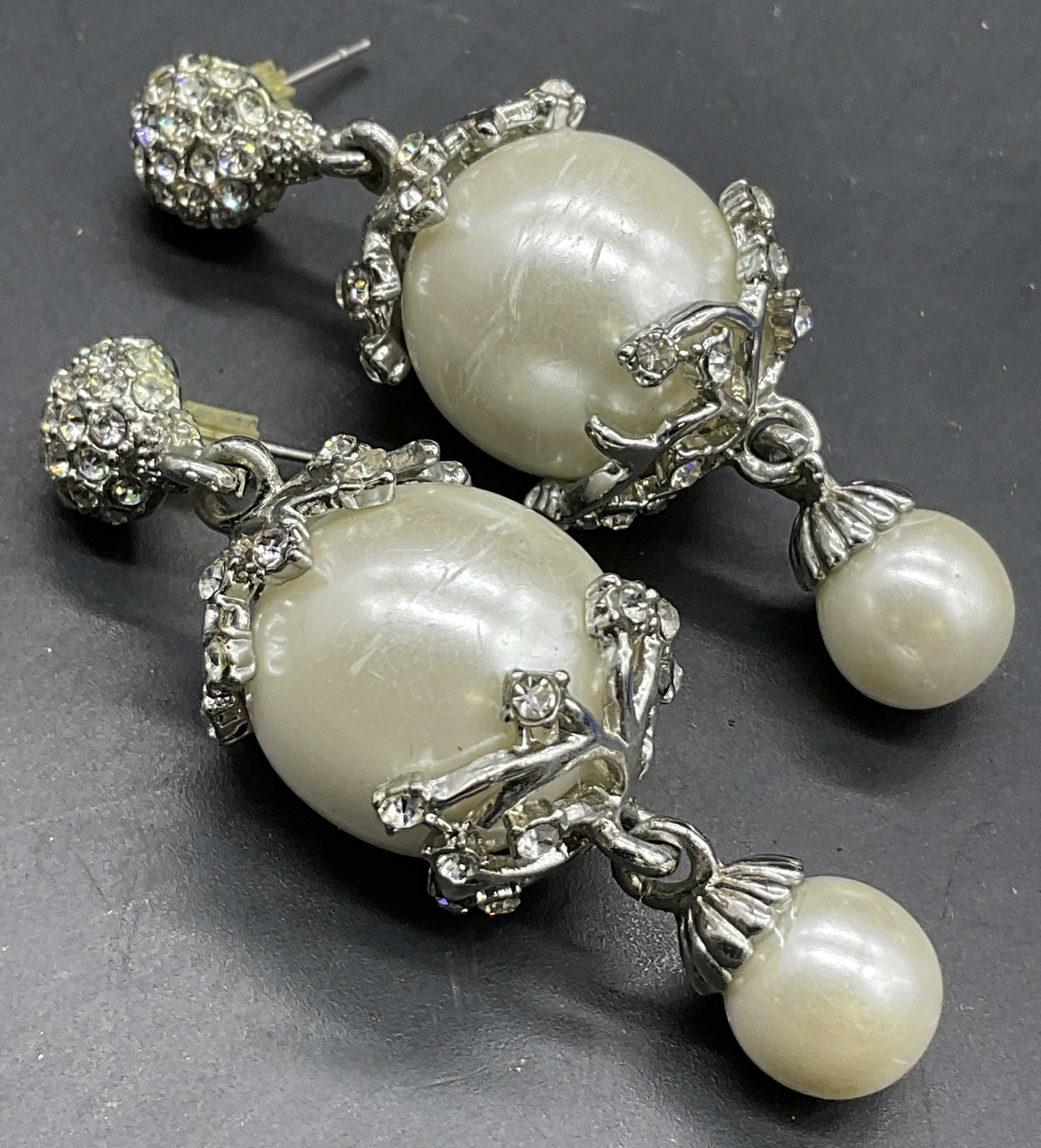 Chunky Bejeweled Pearlescent Drop Earrings: Chunky Bejeweled Pearlescent Drop Earrings. Faceted crystals throughout alongside faux pearls. Metal post backings. Measures approx. 2.25L x .75W in. Surface wear consistent with age, use, and exposur