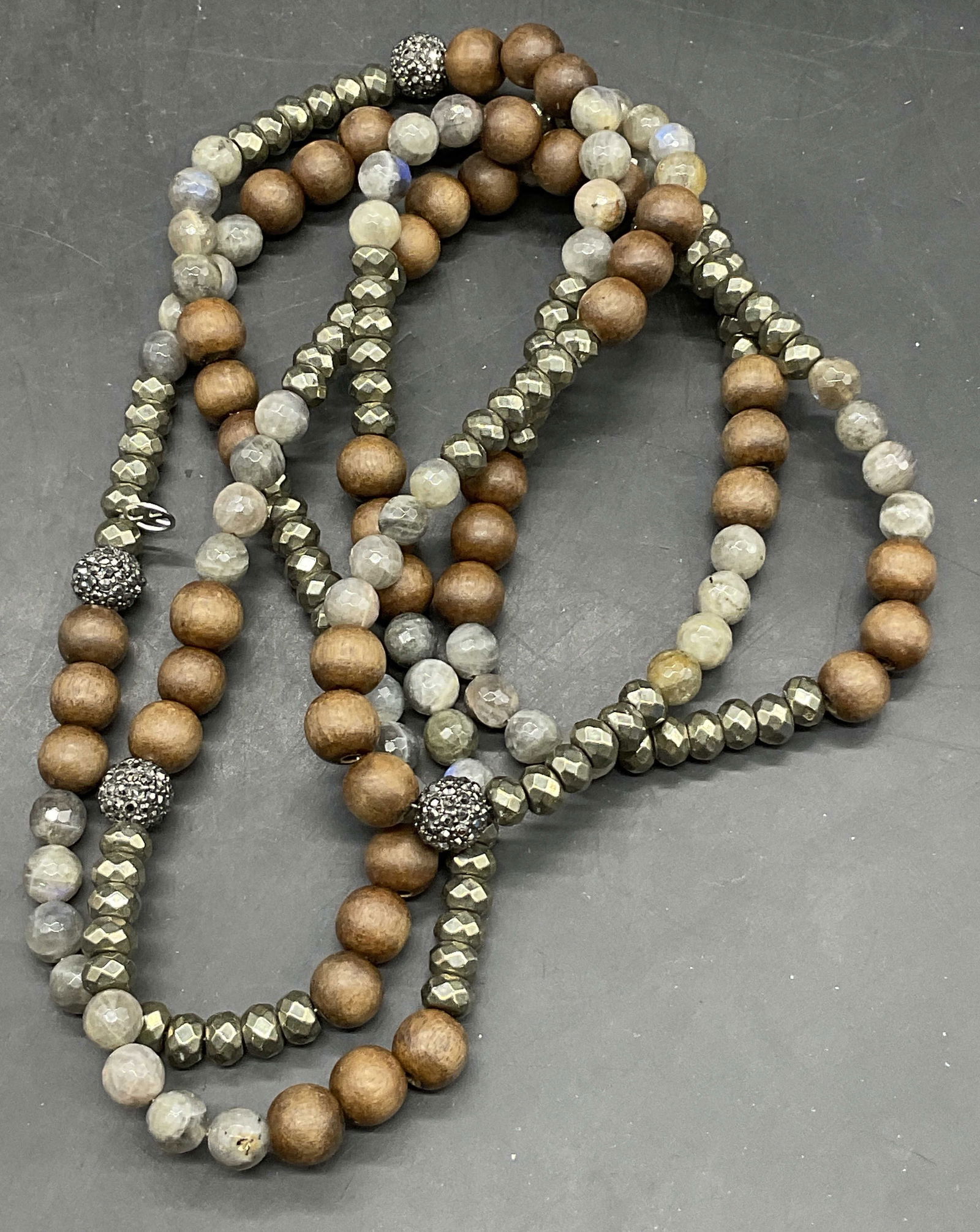 Natural Stone, Wood & Crystal Beaded Necklace: Natural Stone, Wood & Crystal Beaded Necklace. Comprised of faceted crystal beads, faceted natural stone beads, faceted metallic beads, and wooden beads. Peace sign charm to the necklace as well, poss