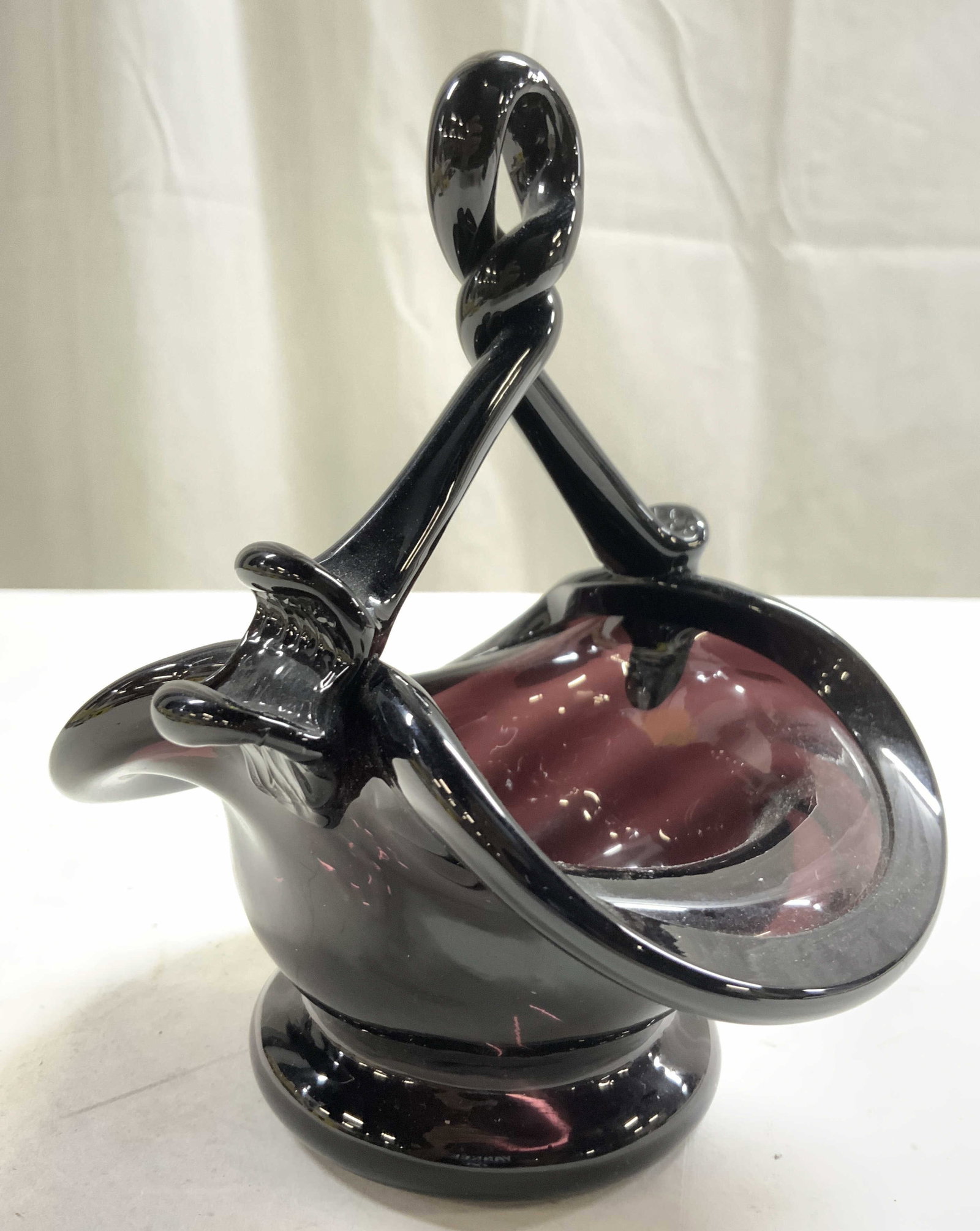 MURANO Hand Blown Art Glass Vessel W Handle: Vessel appears to be MURANO Glass (no apparent markings). Piece appears to be hand blown due to pontil on underside. Piece is dark plum toned. Piece has handle with twisted structure. Vessel measures 