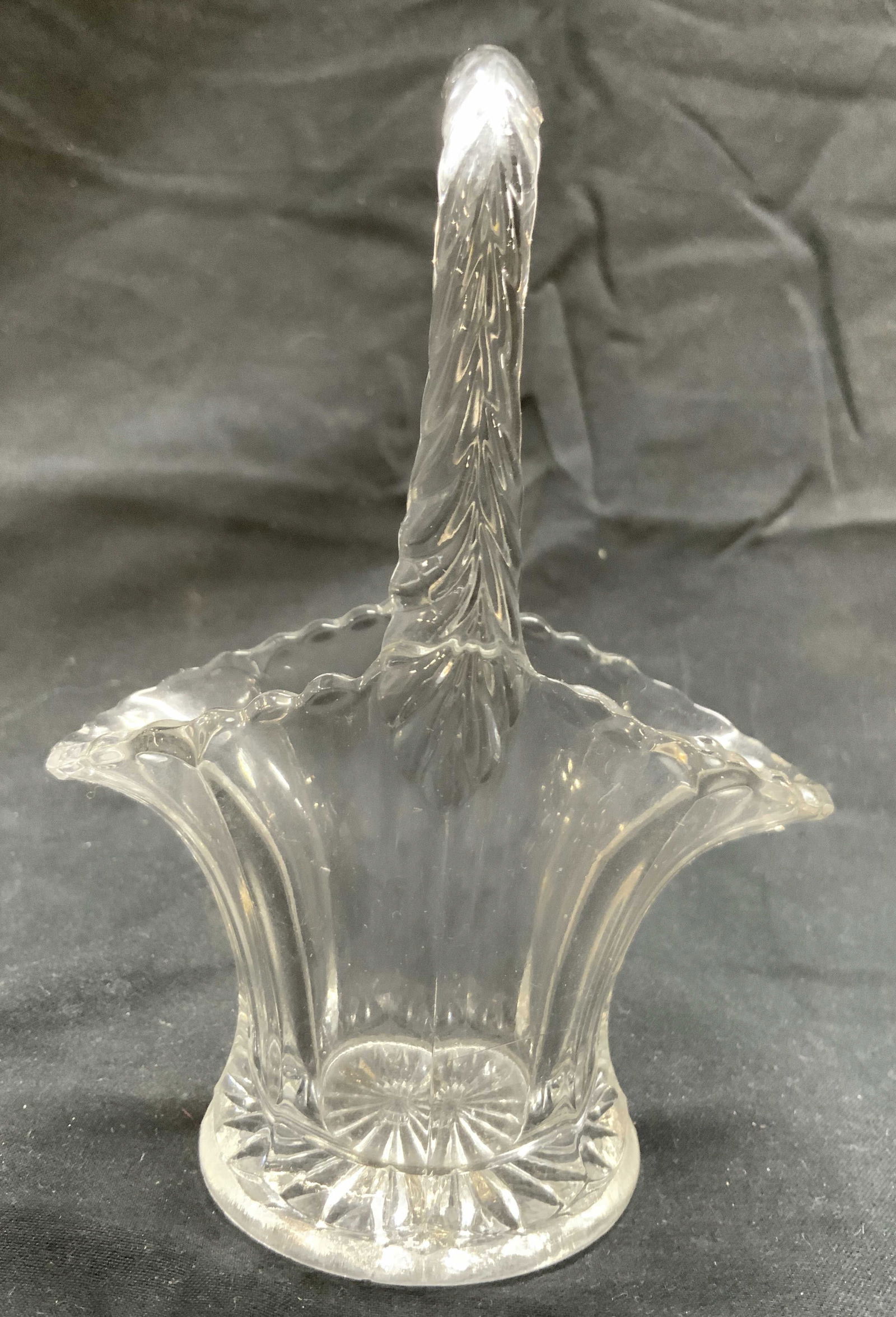 Vintage Art Glass Basket Vessel: Vessel is glass. Piece is in the form of a basket. Vessel has arch form handle. Vessel rim has rounded teeth. Basket figure measures approximately 5 inches tall 3.75 inches wide 2.25 inches deep. Vess