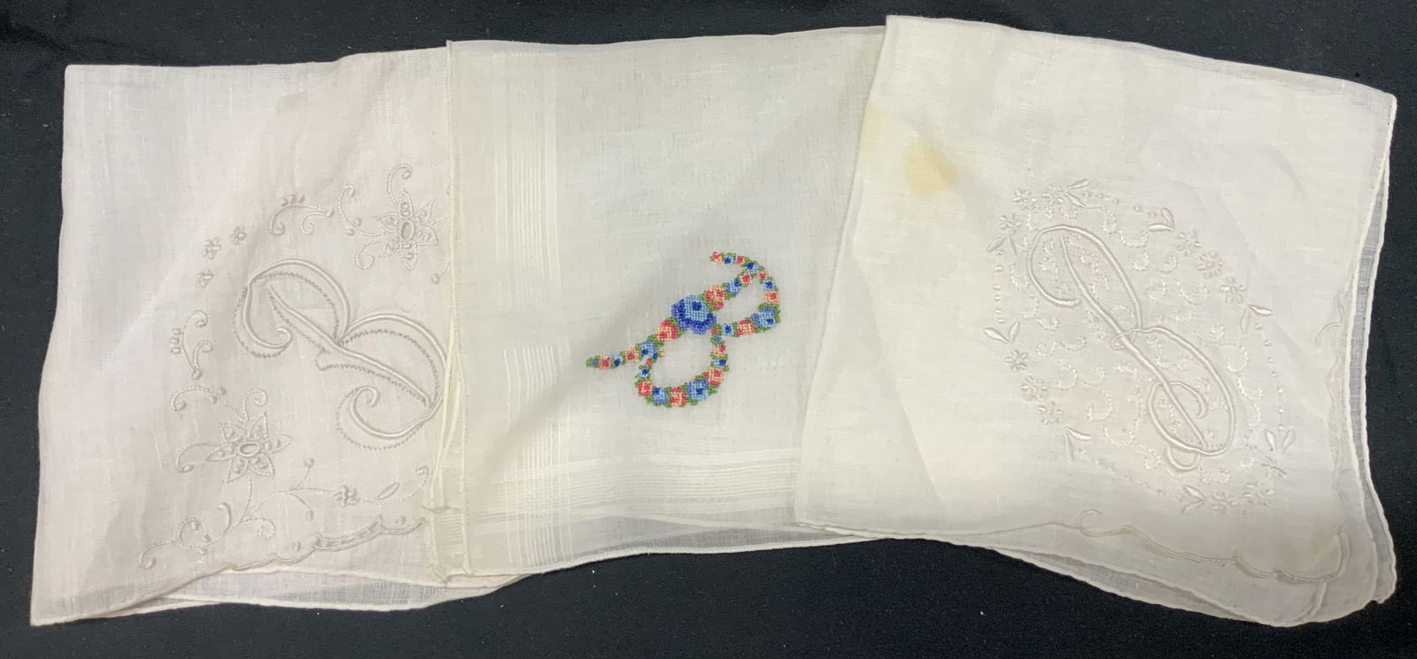Lot 3 White Embroidered Handkerchiefs: Lot 3 White Embroidered Handkerchiefs. 3 embroidered handkerchiefs with the letter B on the corner. One handkerchief has a floral embroidered B. The rest have a white embroidered B. Appears to be line
