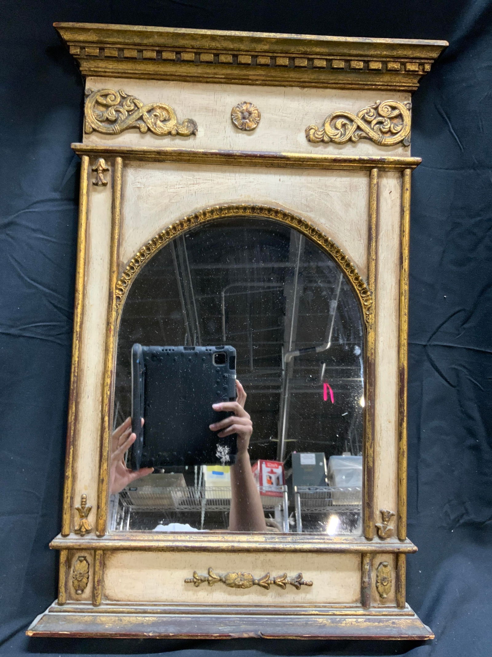 Vintage English Palladian Style Mirror: Mirror is vintage. Piece has cream and gilt detail. Scrolls, flowers & leaves. Mirror frame is wooden. Piece has mirrored surface with arch top. Mirror measures approximately 26 inches tall 17 inches