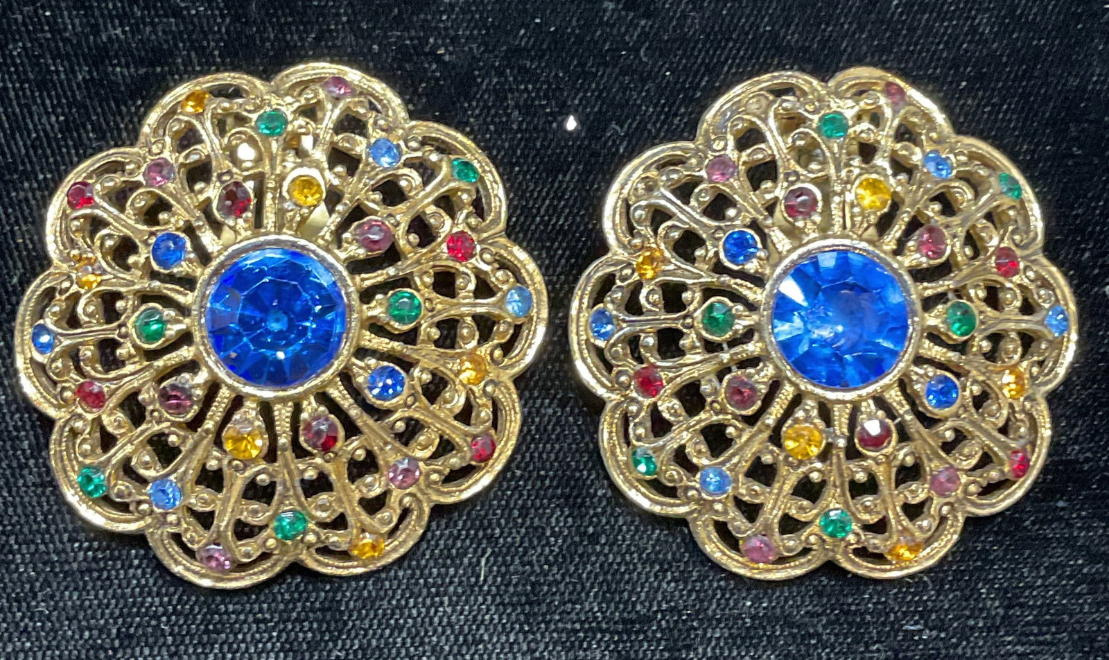 Vintage Gold Tone Crystal Flower Earrings: Vintage gold tone reticulated flower motif earrings with multicolor crystal. Measure approx 1.75 inches wide. Some wear including scratching observed. Jewelry, estate jewelry, costume jewelry, cocktai