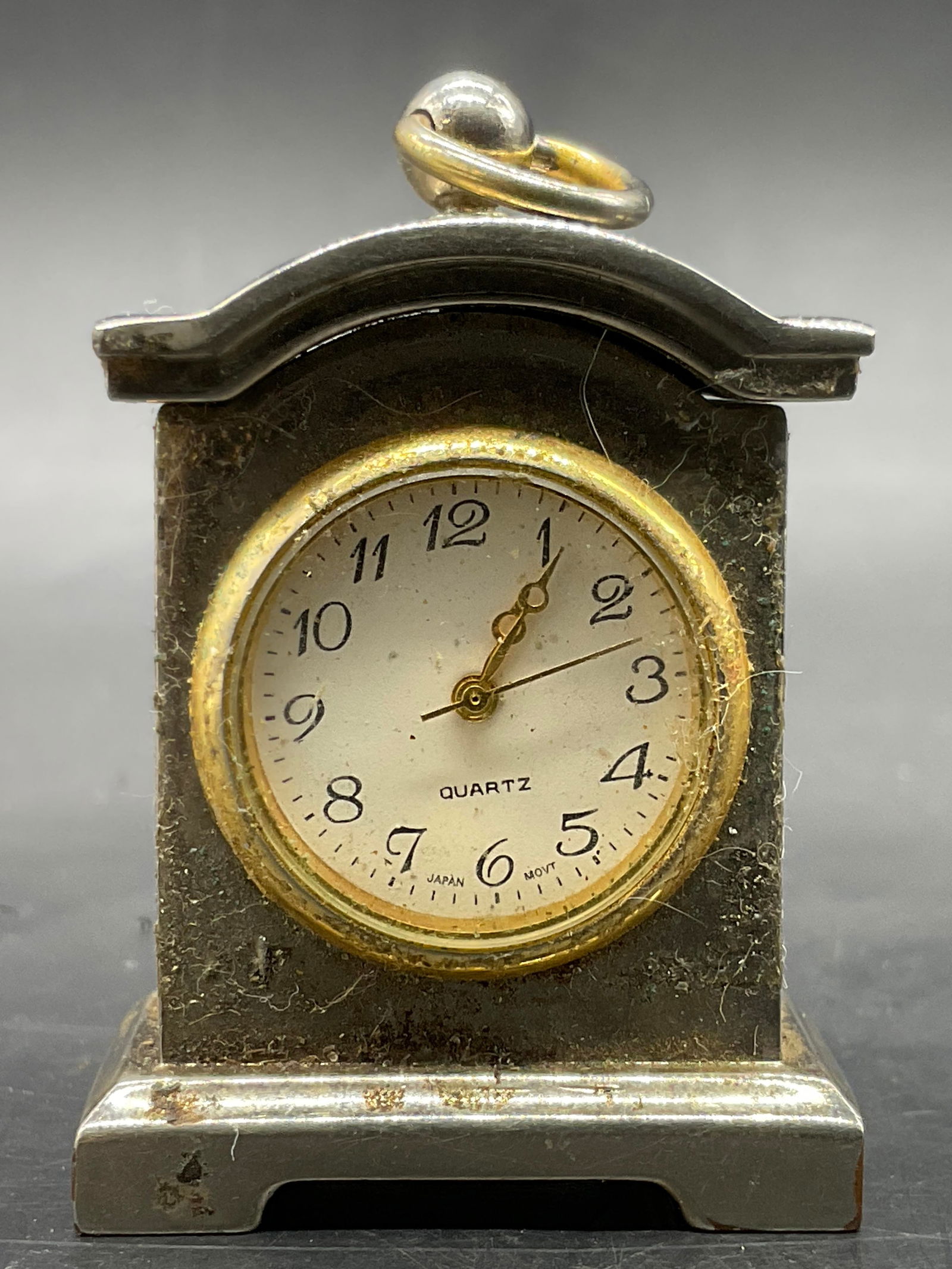 1997 WALLACE Engraved Metal Carriage Clock: 1997 WALLACE Engraved Carriage Clock. Clock face reads Quartz. Reverse reads SLB 1997, WALLACE. Crafted from gold and silver tone metal. Measures approx. 1.5H x 1.25W in. Surface wear consistent with