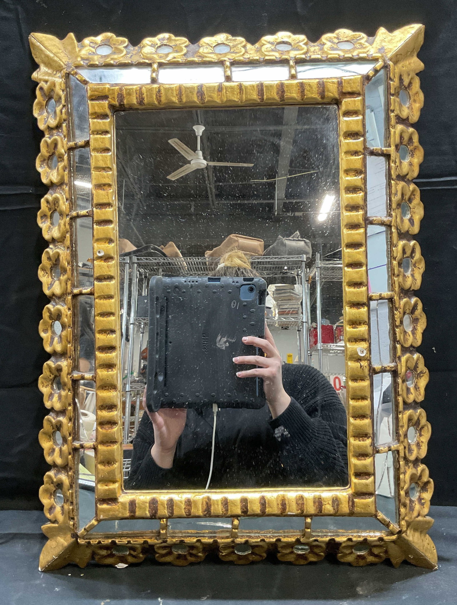 Vintage Carved Gilt Wood Flower Mirror: Vintage gilt wood and gesso mirror with carved flower border. Measures approx 23.75 x 17.5 inches. Some wear including cracking to mirror, frame, and chipping observed. Mirror, vintage mirror, flower 