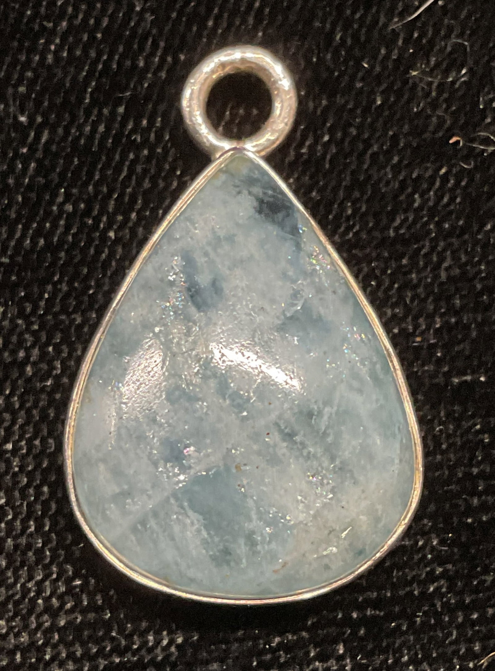 Sterling Silver Blue Semiprecious Drop Pendant: Sterling silver and blue semiprecious gemstone drop shaped pendant. Tests for sterling. Measures approx .75 inches long. Total weight 4.3 grams. Some wear including scratching observed. Jewelry, estat