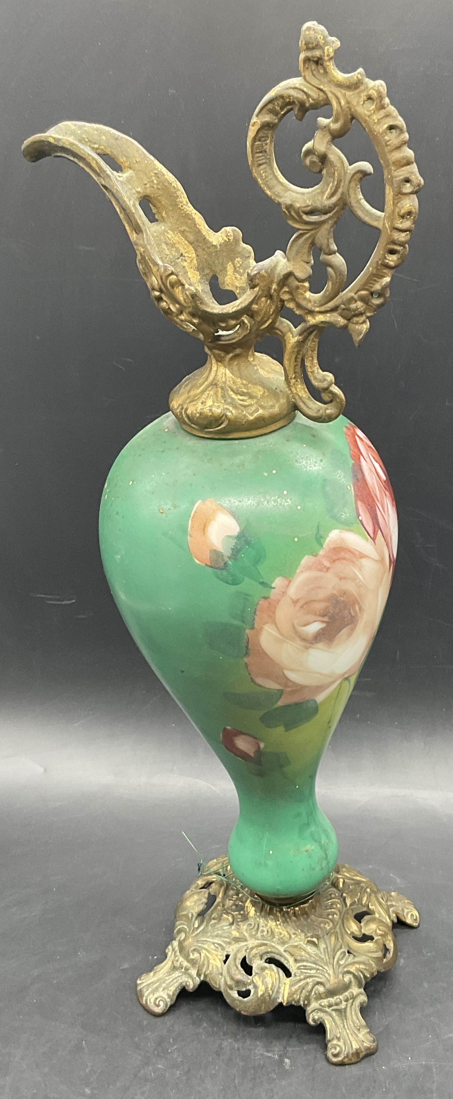 Antique Hand Painted Glass & Metalwork Ewer: Antique Hand Painted Glass & Gilt Metalwork Ewer. Floral design to the glass body. Ornate gilt metalwork to the top and base of the piece attached by hardware. Underside numbered 304. Measures approx.