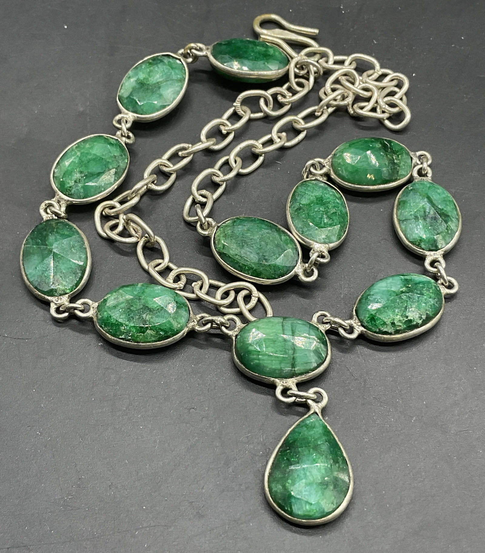 Natural Faceted Green Stone Sterling Silv Necklace: Natural Faceted Green Stone Sterling Silver Necklace. Total weight .78 ozt. The fish hook clasp is marked 925. Necklace length measured end to end approx. 17.5 inches. Surface wear consistent with age